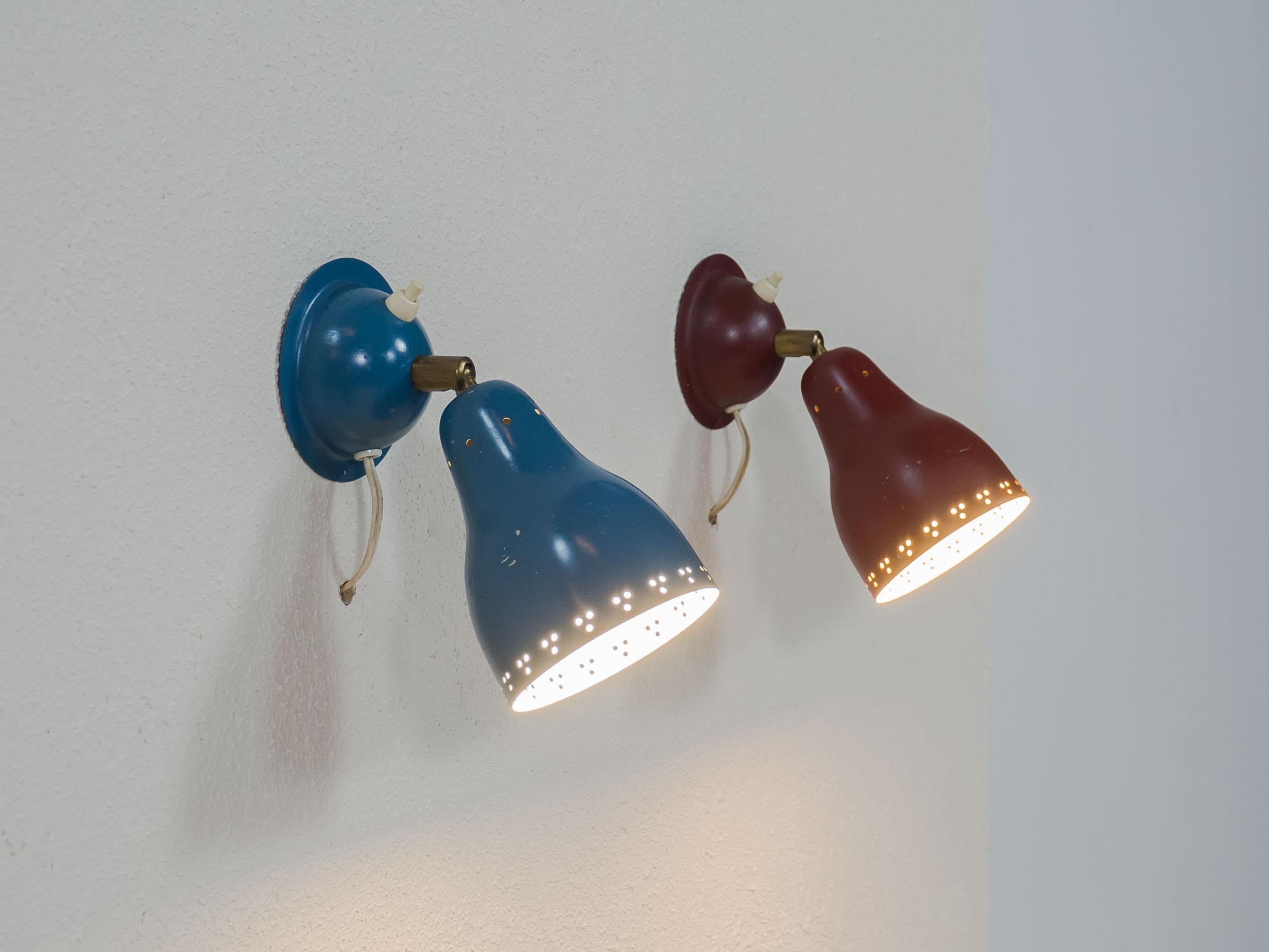 Set of two Swedish wall lights, most likely from the 1950s.

The two lamps are in their original blue and red lacquer, and have their original switches and swivels. They can be attached to a wall via a single screw.

The lamps are in all original