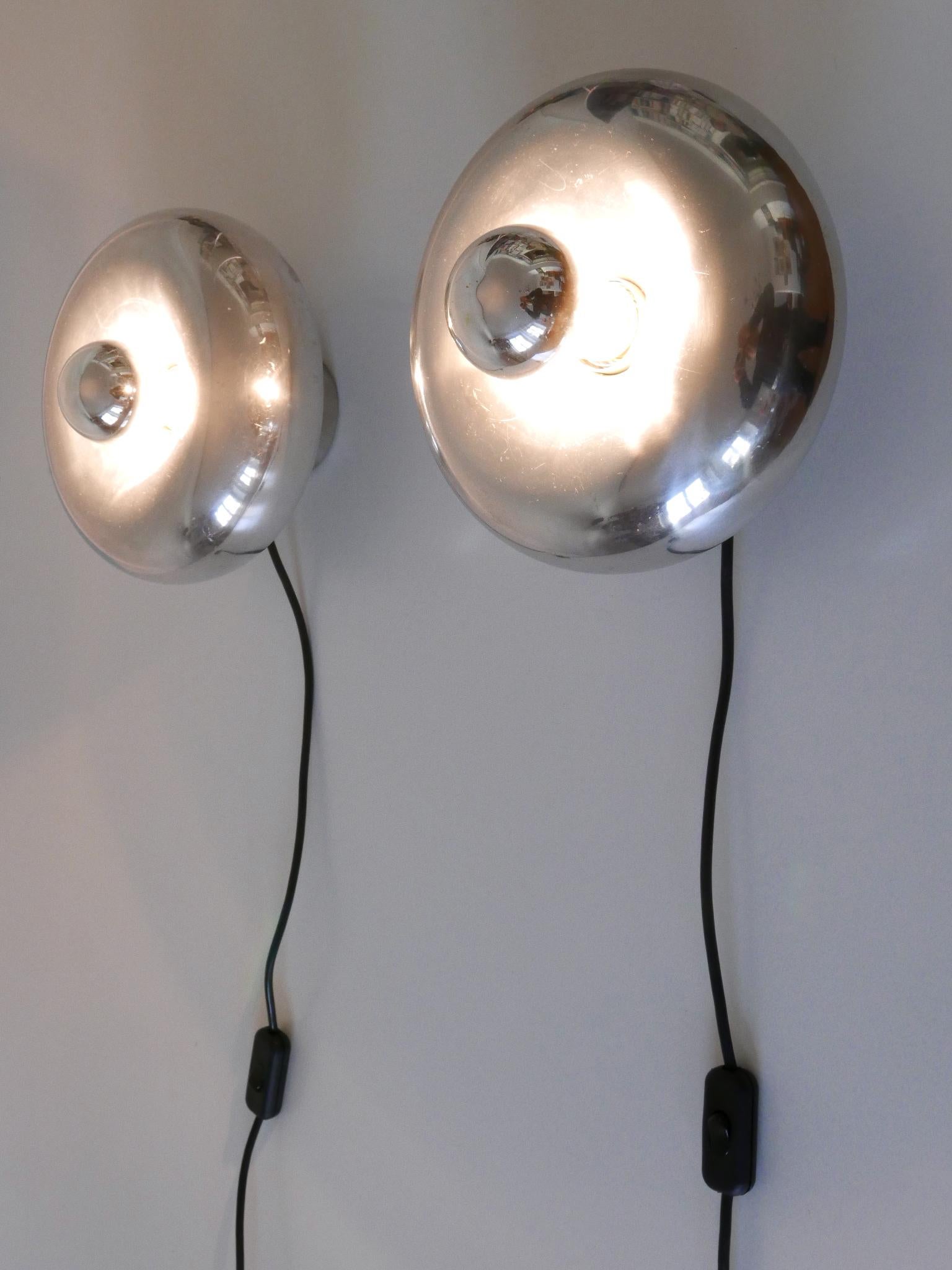 Set of two rare and elegant Modernist sconces or table lamps 'Pox' in donut shape. Adjustable height. Designed by Ingo Maurer for Design M, Germany, 1960s.

Executed in aluminium and metal, each lamp needs 1 x E27 / E26 Edison screw fit bulb, is