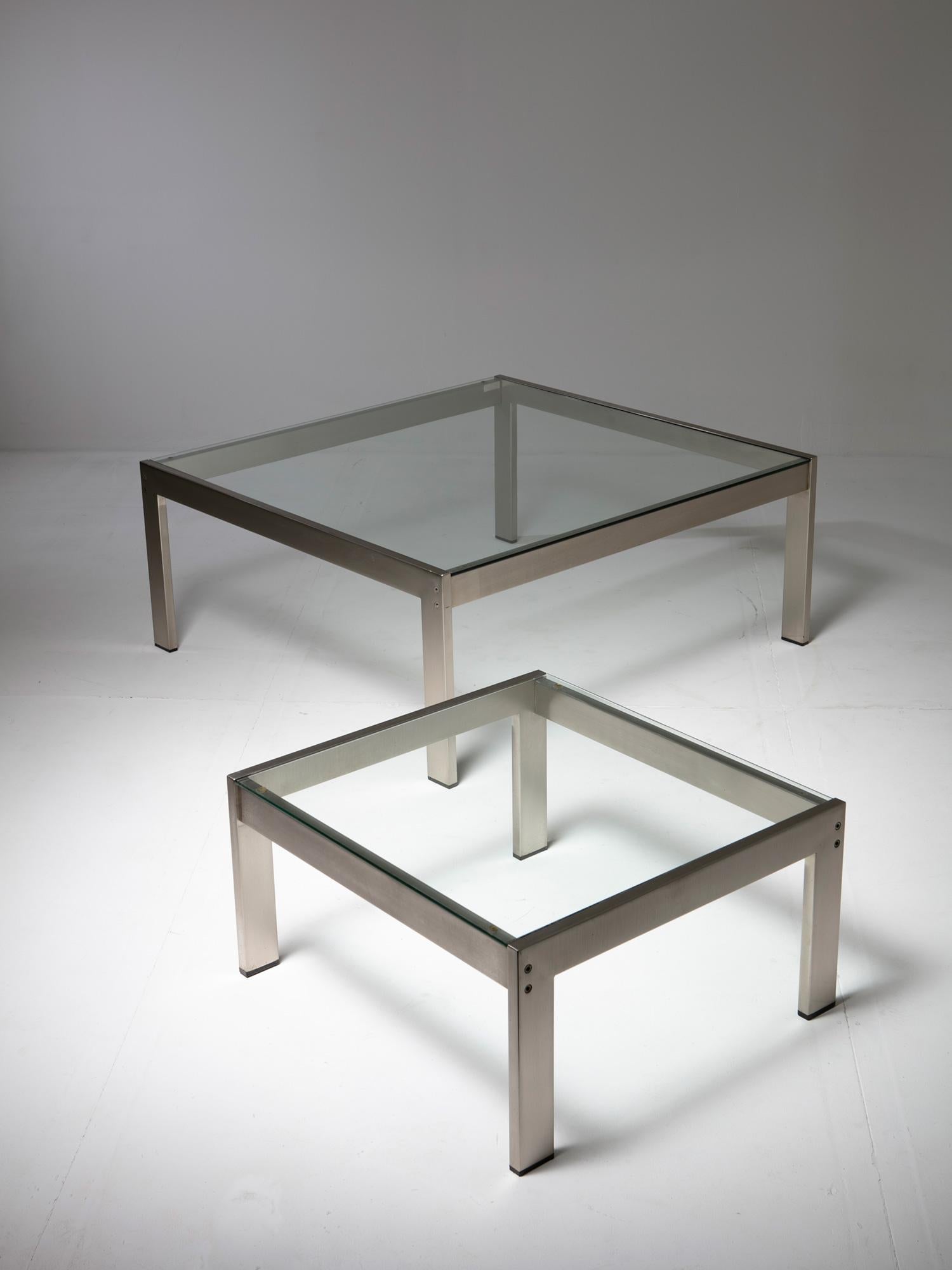 Remarkable pair of Tau tables by Gae Aulenti for La Rinascente.
Thick glass top on a sturdy brushed steel frame with underlined construction details.
