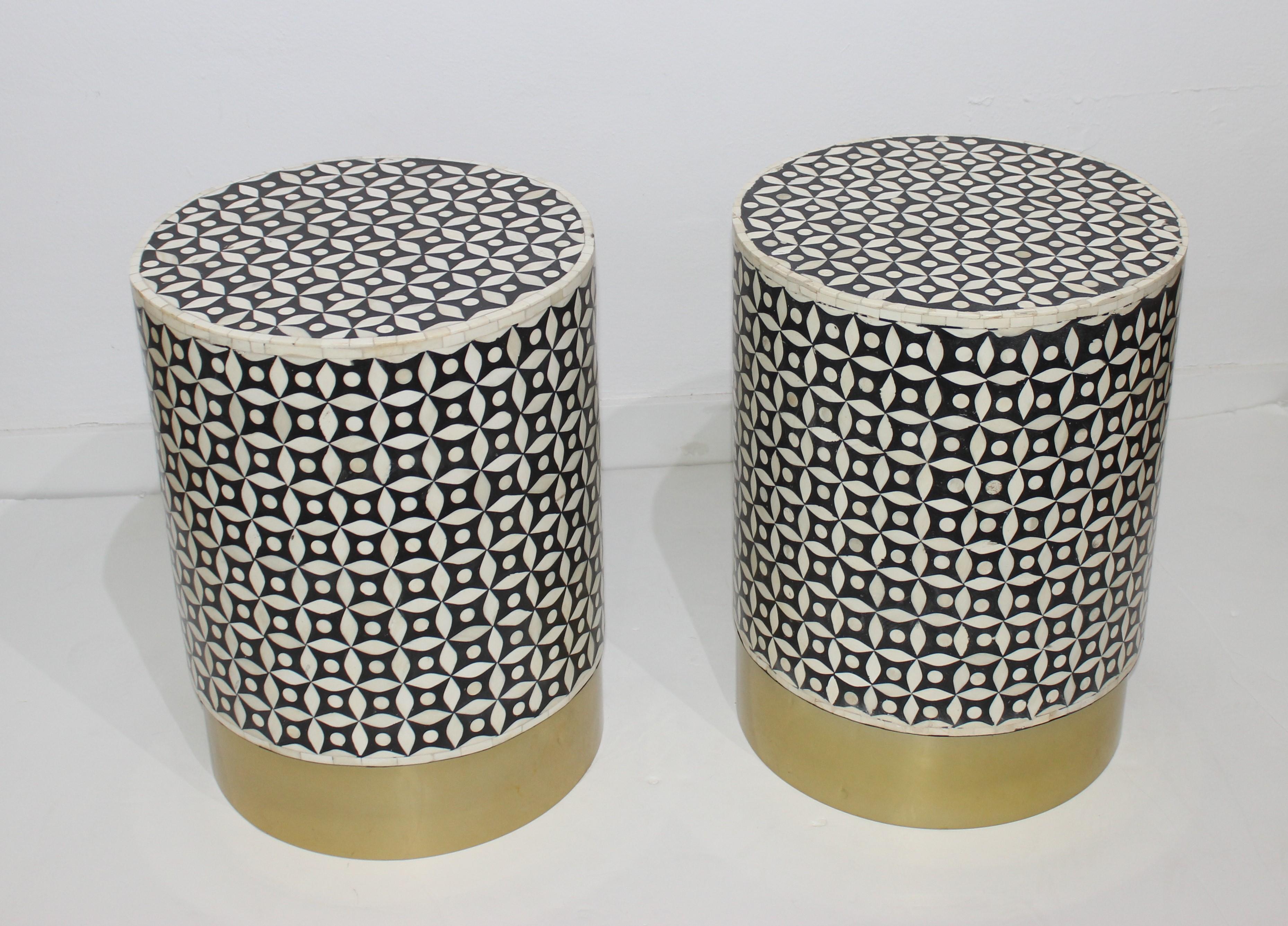 This stylish set of two handcrafted drum tables date to the 1990s and are fabricated in black and white tessellated bone and a satin brass base.

Note: Dimensions of one drum is 19.13