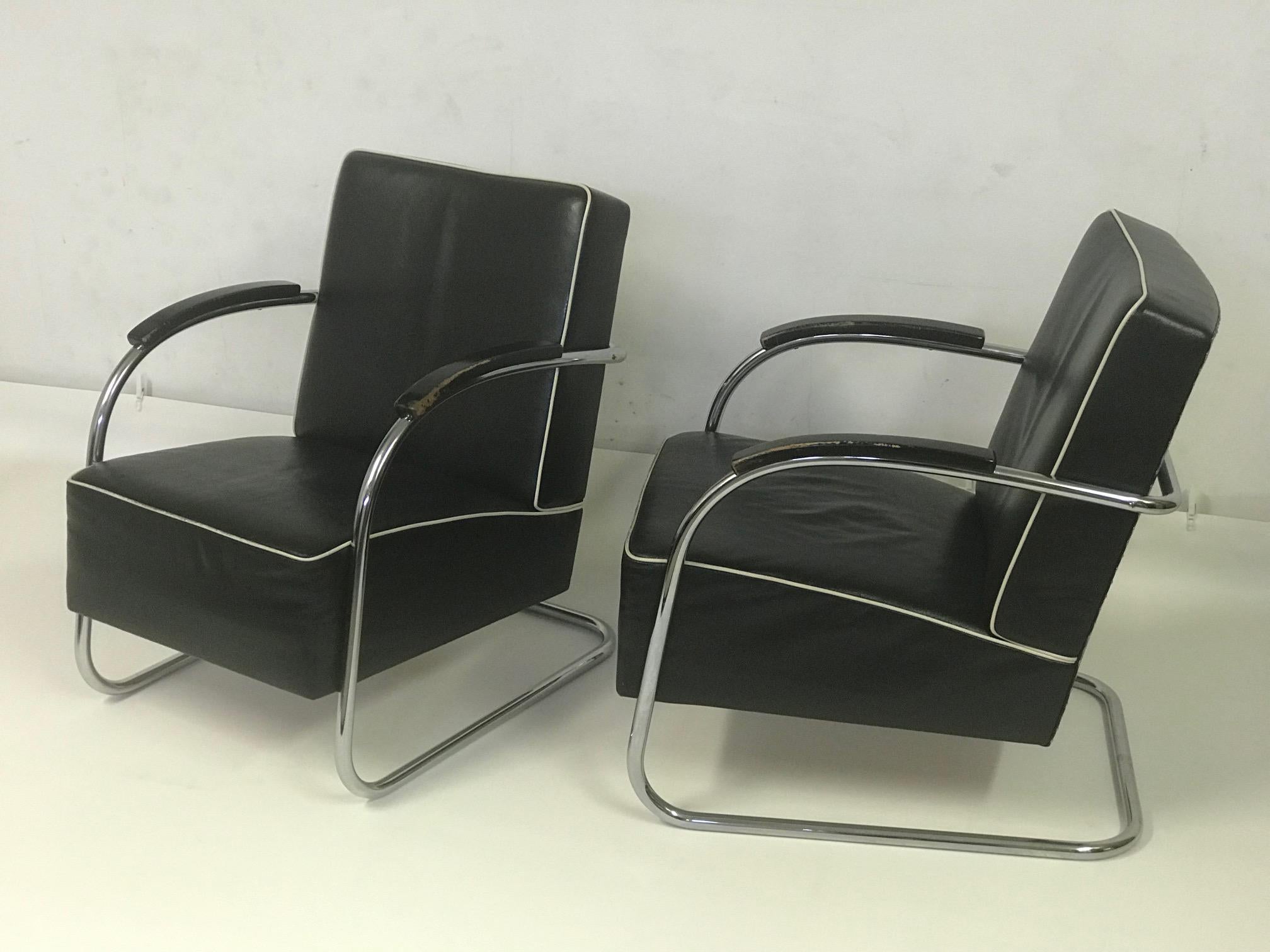 The chairs are made of the steel chromed construction. The seats are made of black leather completed with white rim. They are in a good condition.