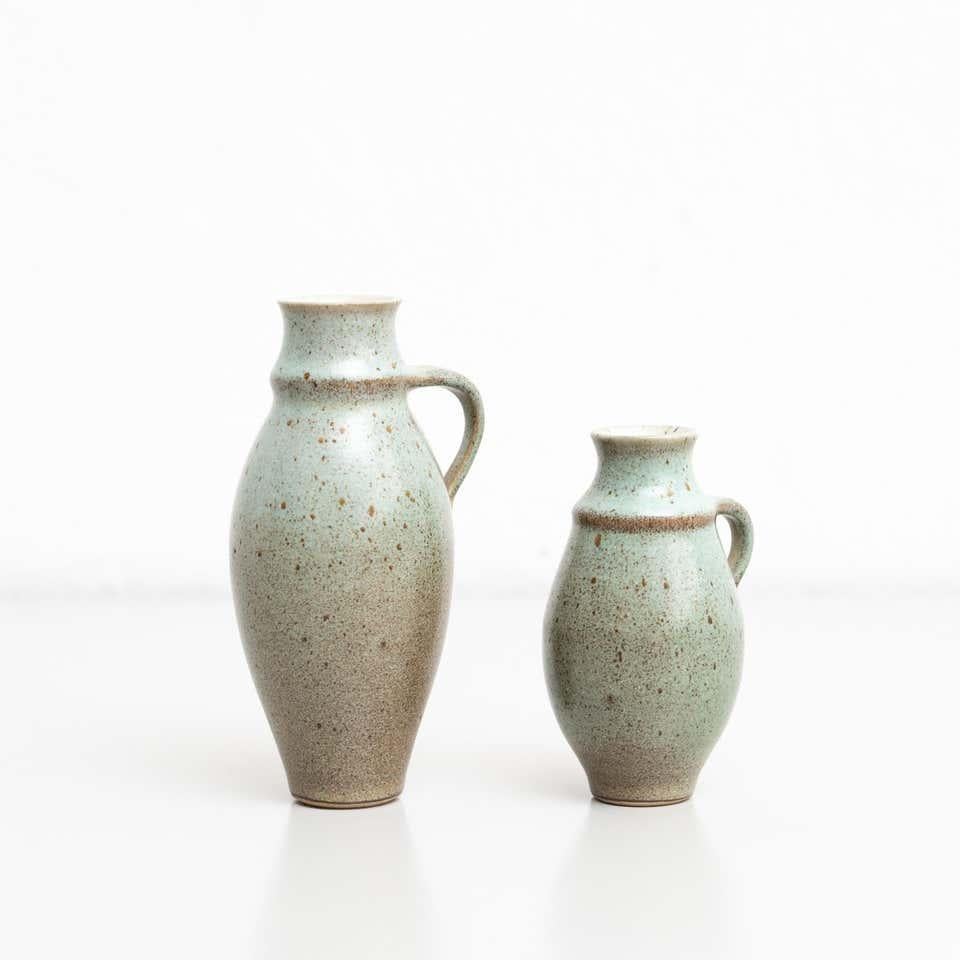 Set of two vintage ceramic vases.

By unknown manufacturer, made in Spain circa 1950.

In original condition, with minor wear consistent with age and use, preserving a beautiful patina.

Materials:
Ceramic.
