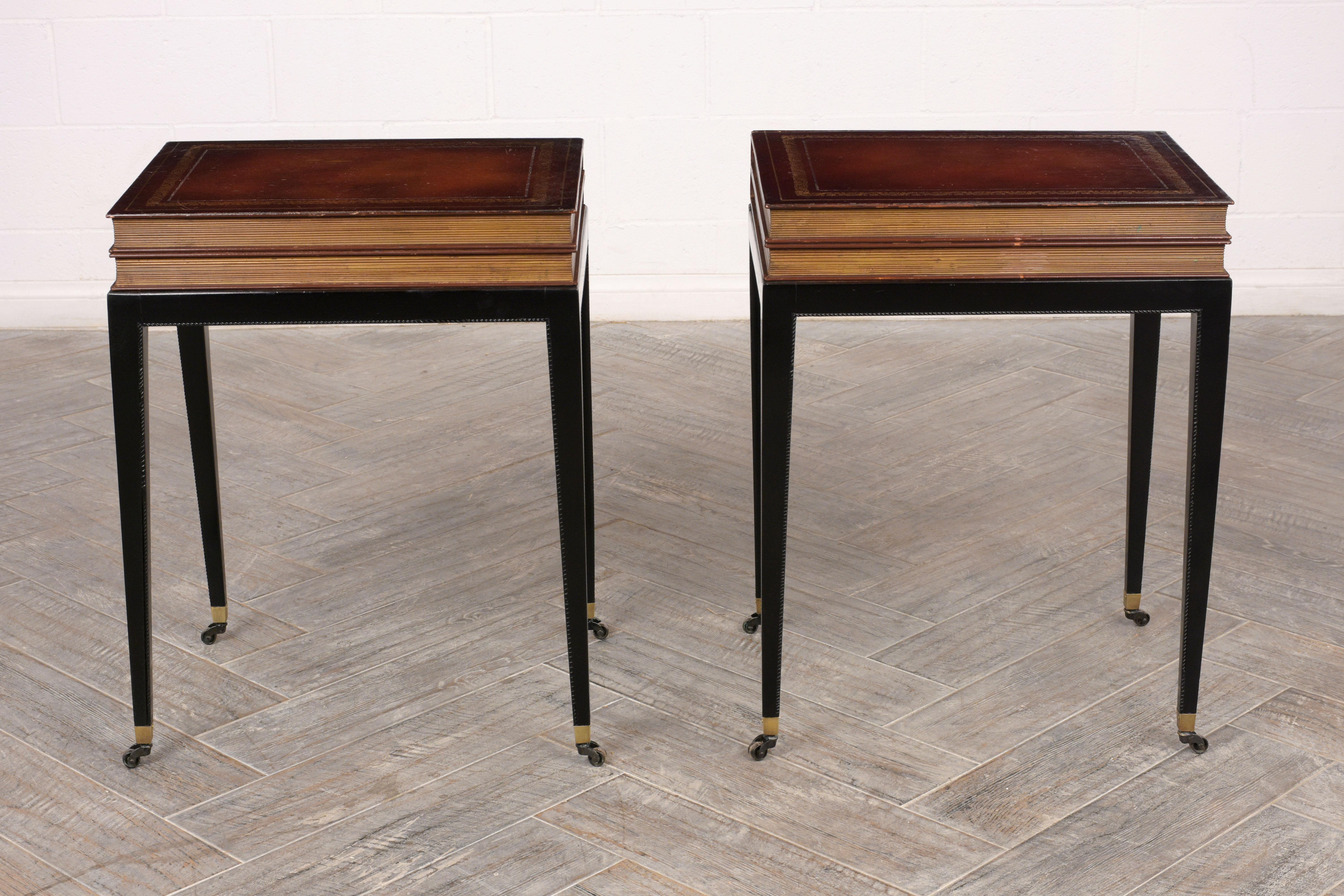 Pair of unique book design side tables. Made from mahogany, top book design has original paint and details, base and legs, are newly stained in a rich ebonized color with a lacquered finish. Features a top drawer that can be opened from the sides.