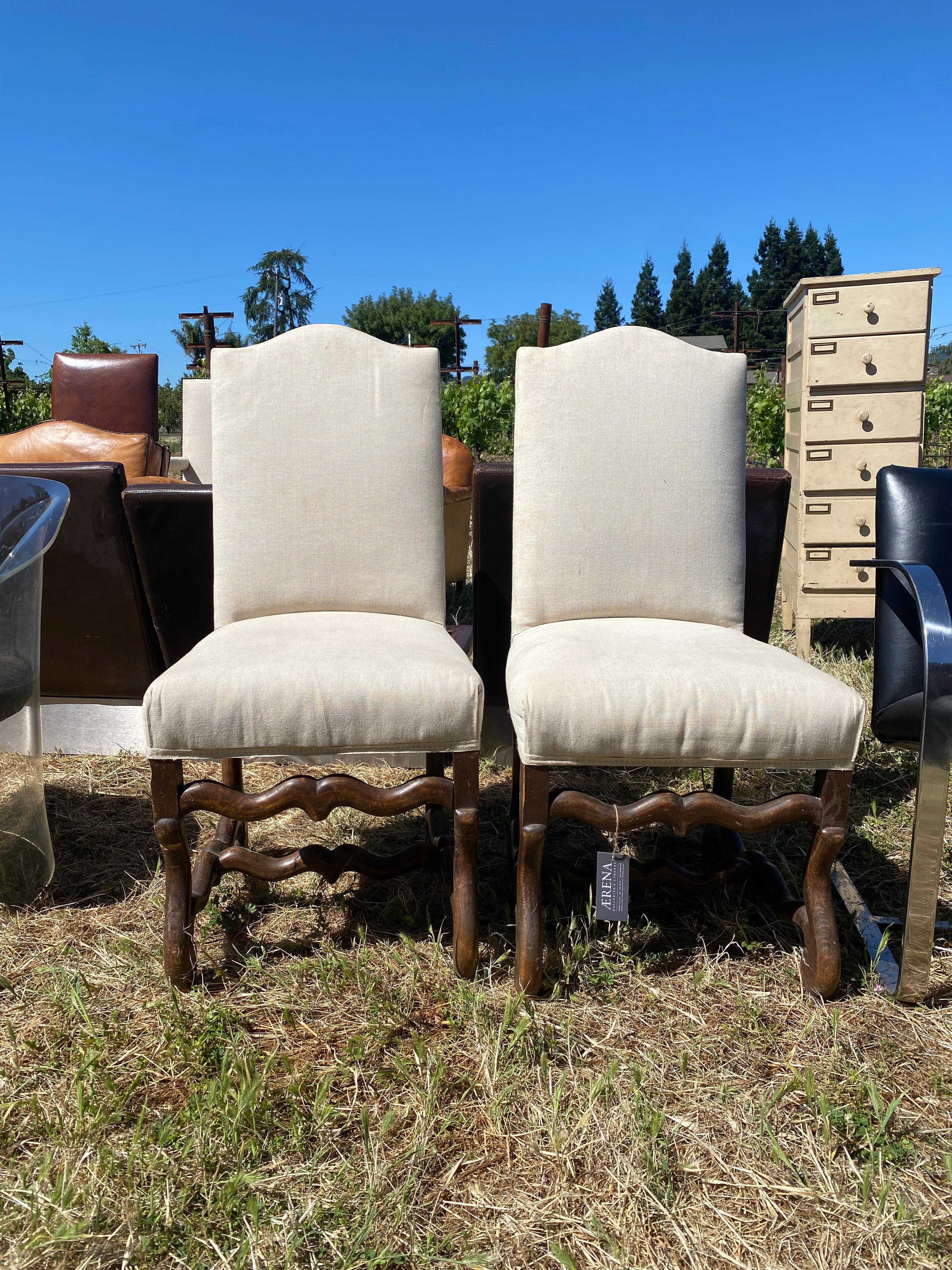 Two Louis VIII style chairs made in France in 1860 with deeply patinaed ash, upholstered in white linen.