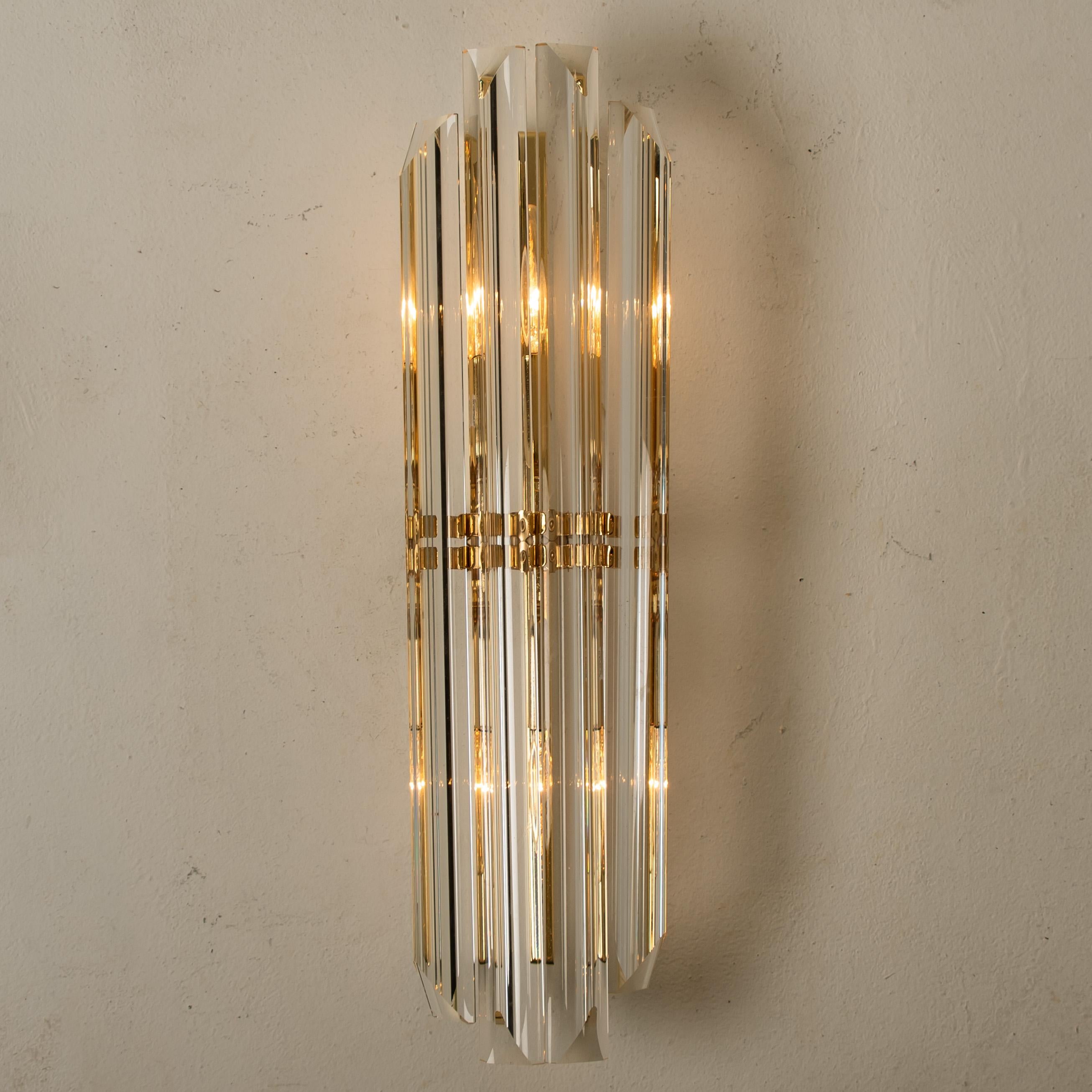 Beautiful pair of Murano glass wall sconces featuring four long crystal clear glass 