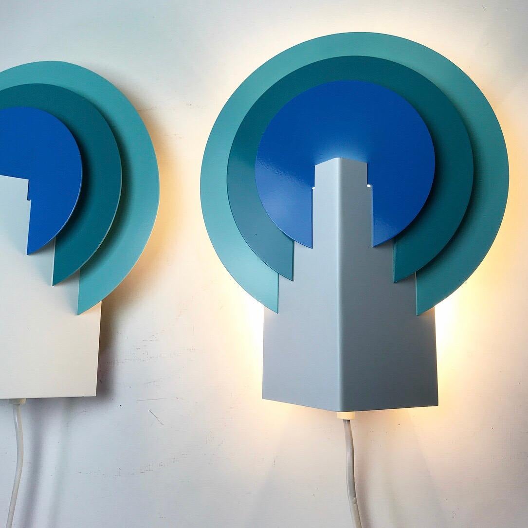 Almost like Mephis styled wall sconces this beautiful set by Lyskaer of Denmark 1970s will certainly bright up your interior - whether they are lit or not. 

Three colored wall light has a cool Scandinavian design and the color shades of blue and