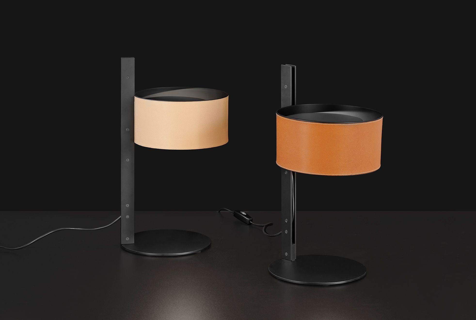 Set of Two Table Lamps model Parallel designed by Victor Vasilev in 2022.
Table lamp in metal giving direct light. Base, stem and closing disk in lacquered matt black, reflector covered with leather. With universal dimmer.
Manufactured by Oluce,