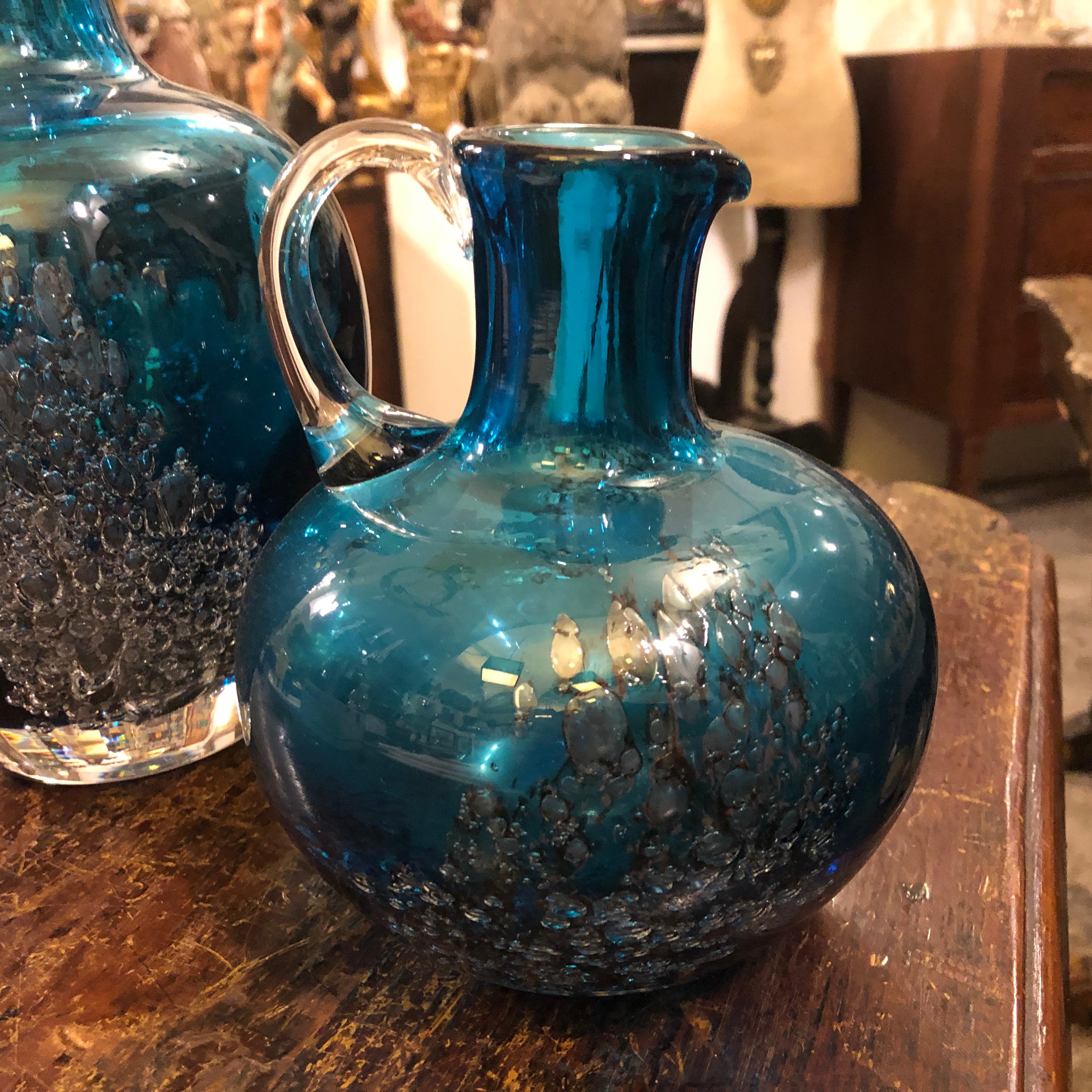 Two particular blue glass jugs in perfect conditions manufactured in Germany by Schott Zwiesel, diemnsion of the small jug size height cm 17, diameter cm 14.
