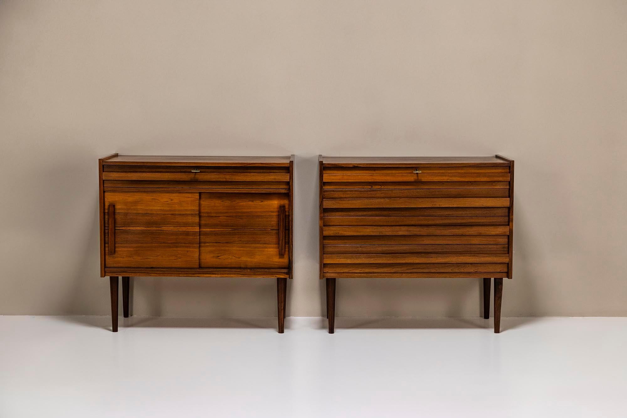 Charming set of two vintage cabinets in veneered rosewood from Denmark, most probably the 1960s. This set consists of a chest of drawers and one cabinet with a drawer and two sliding doors. The cabinets can be used all together as a sideboard or