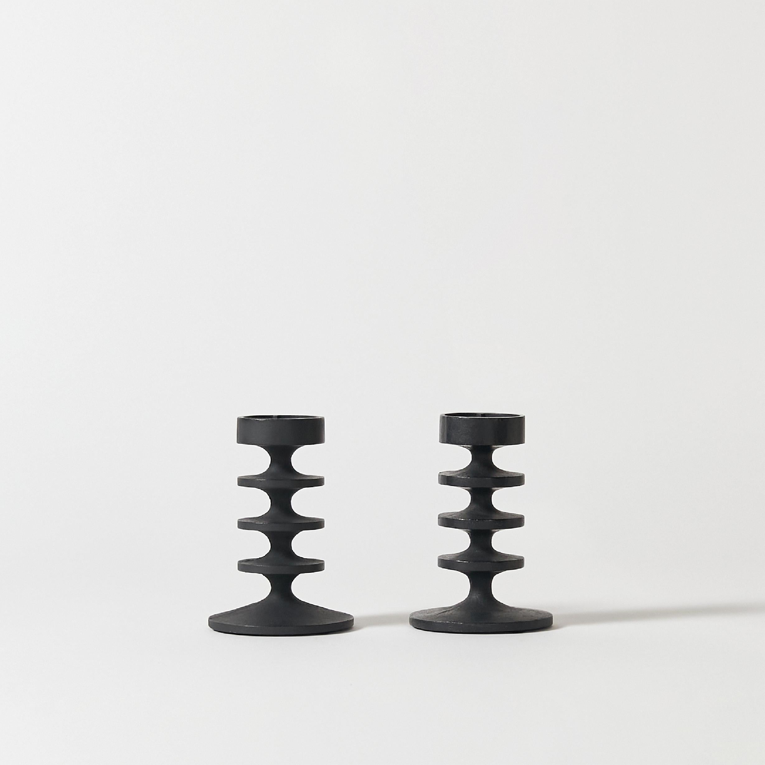 Set of two candlesticks in blackened cast iron designed by Robert Welch. Signature stamp on bottom.