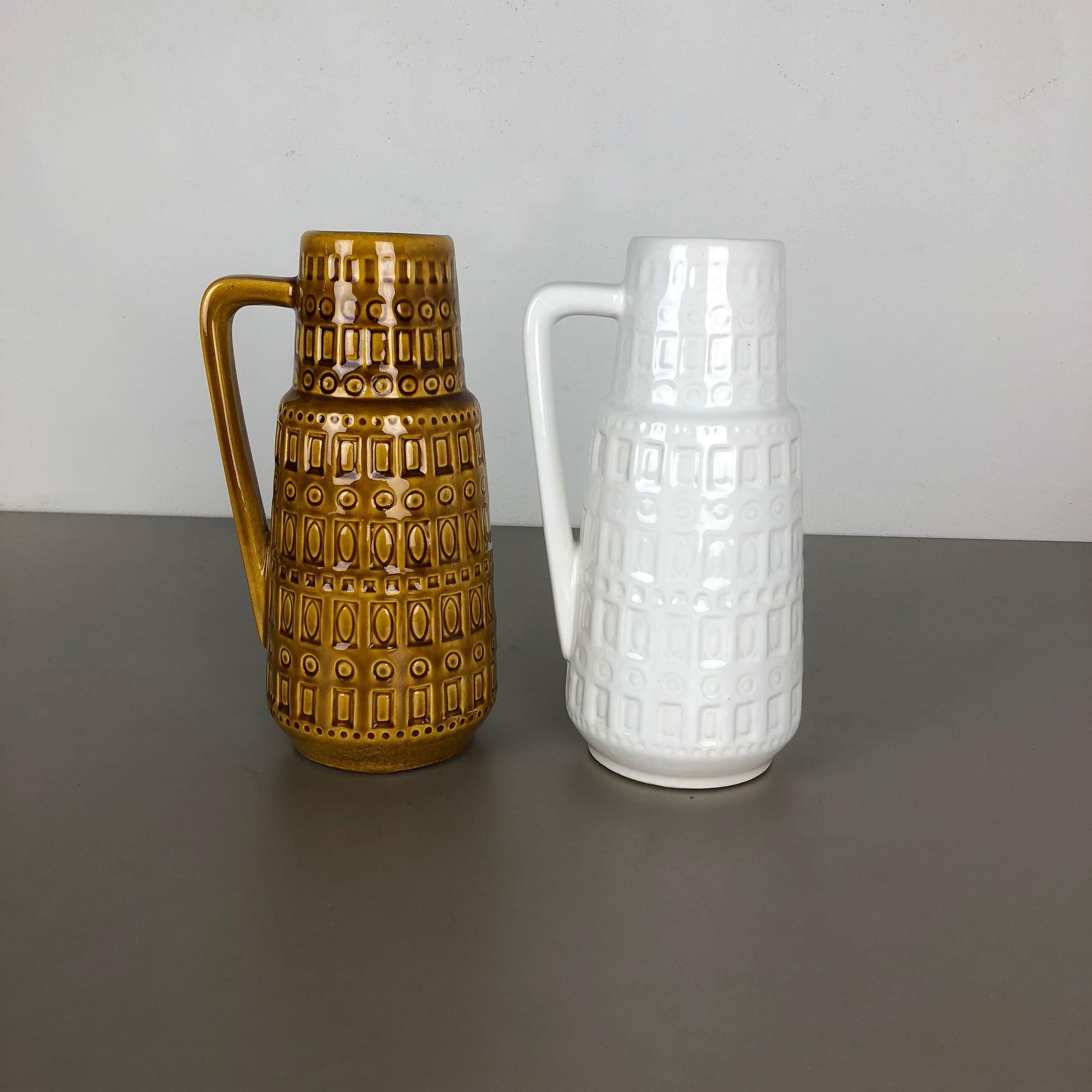 Article:

Set of two fat lava art vases


Producer:

Scheurich, Germany


Design:

Nr. 416 26



Decade:

1970s




This original vintage Vase was produced in the 1970s in Germany. It is made of porcelain in fat lava optic.