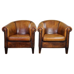 Set of two vintage sheep leather club armchairs