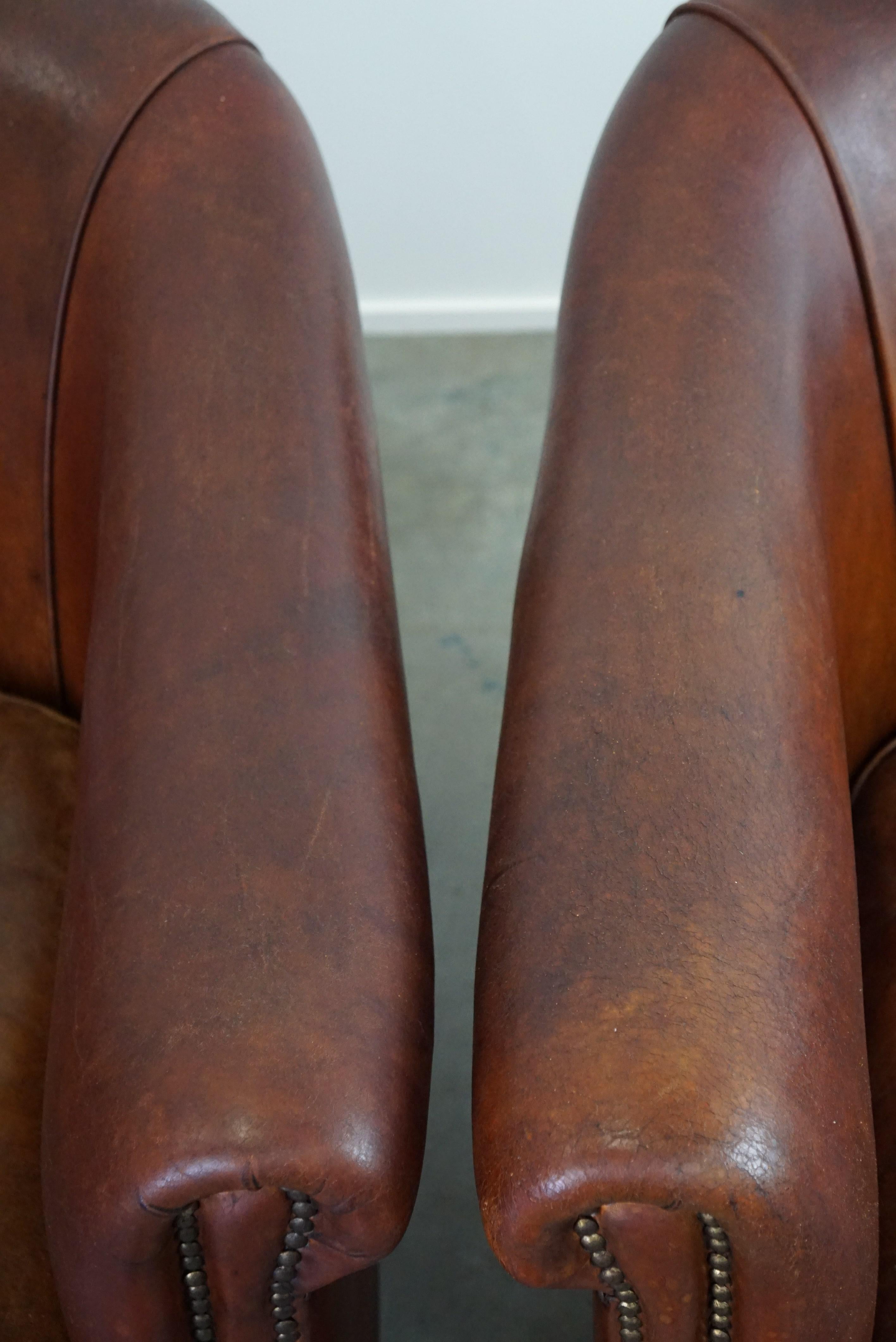 Set of two vintage sheep leather club armchairs with a rugged character For Sale 4