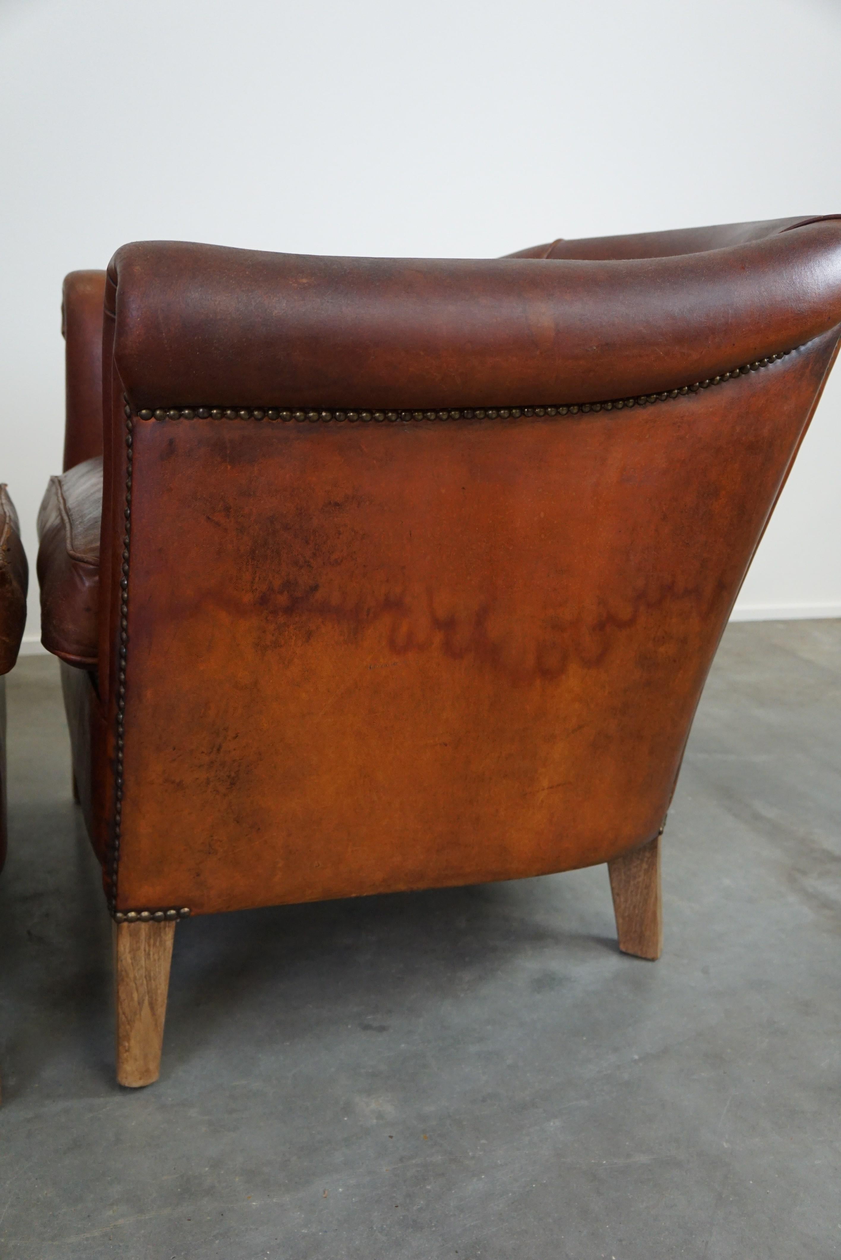 Set of two vintage sheep leather club armchairs with a rugged character For Sale 6