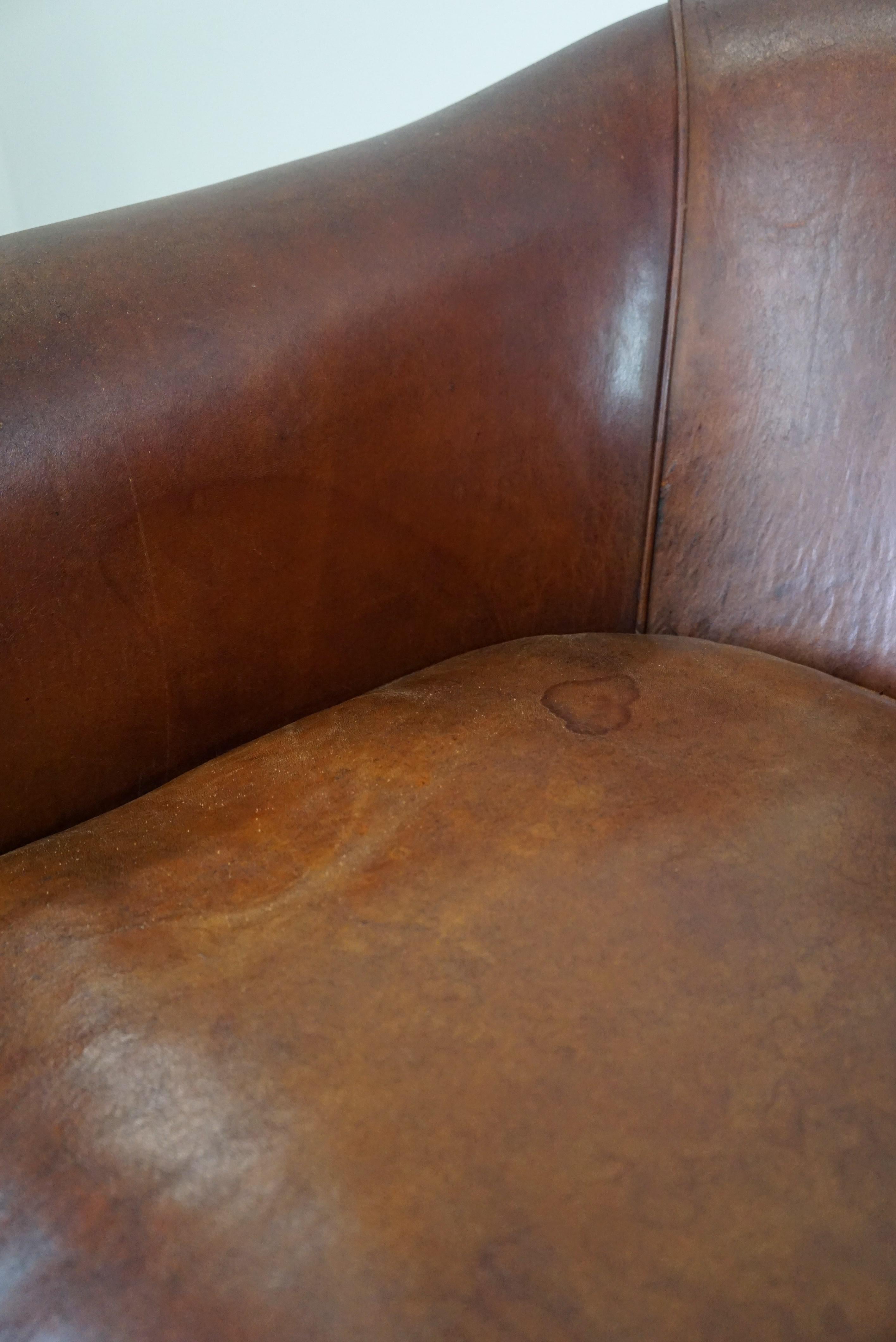 Set of two vintage sheep leather club armchairs with a rugged character For Sale 9