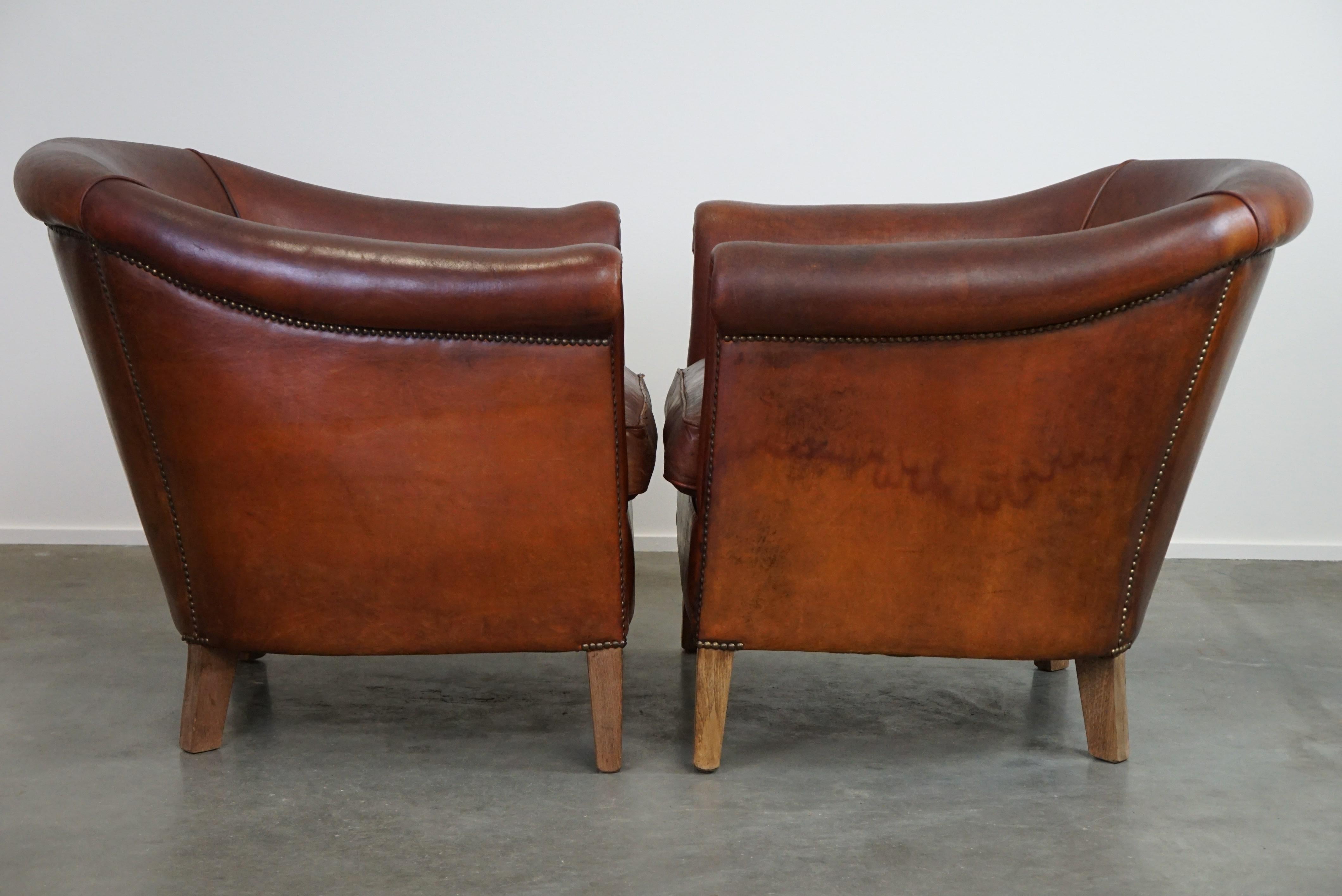 Dutch Set of two vintage sheep leather club armchairs with a rugged character For Sale