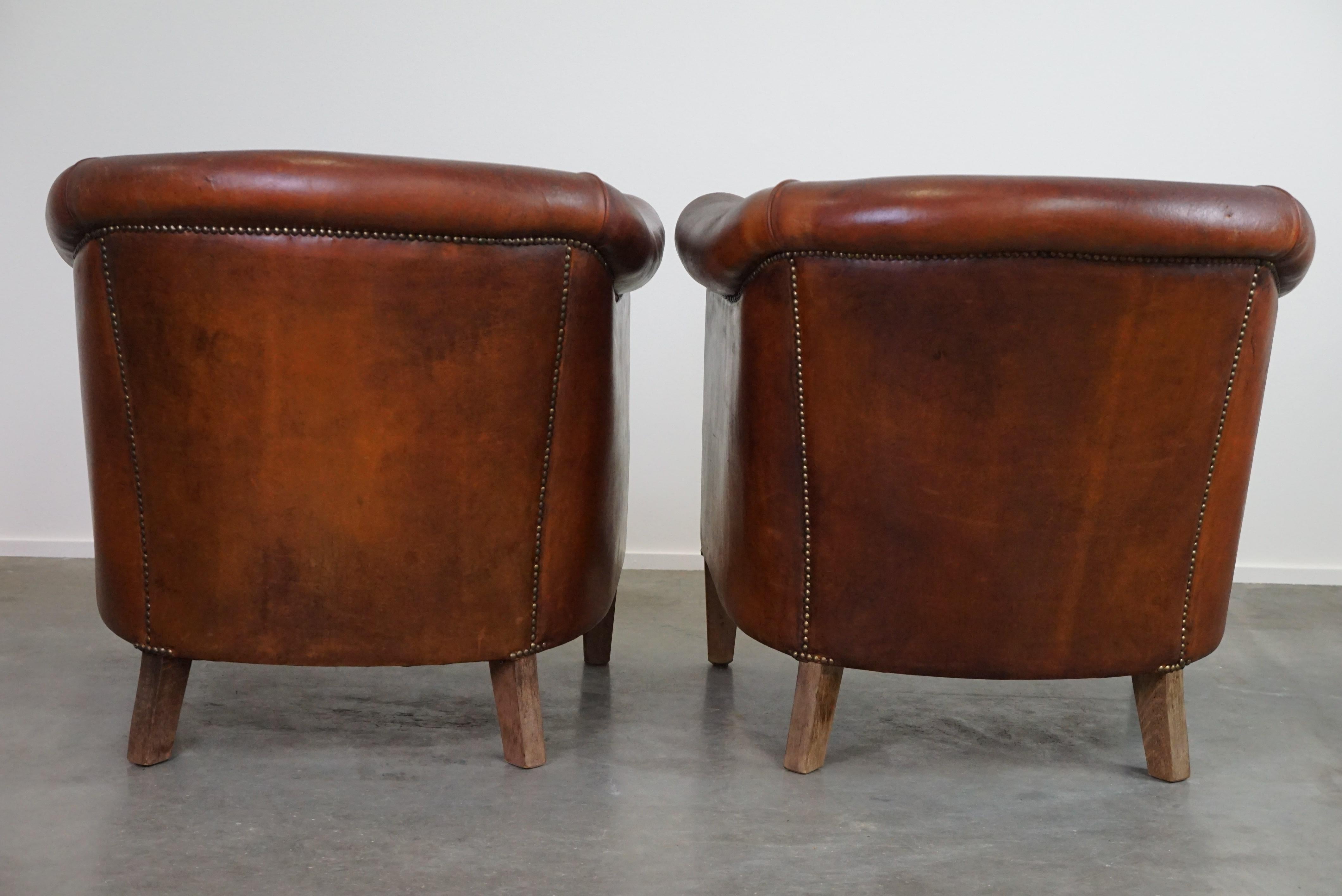Hand-Crafted Set of two vintage sheep leather club armchairs with a rugged character For Sale