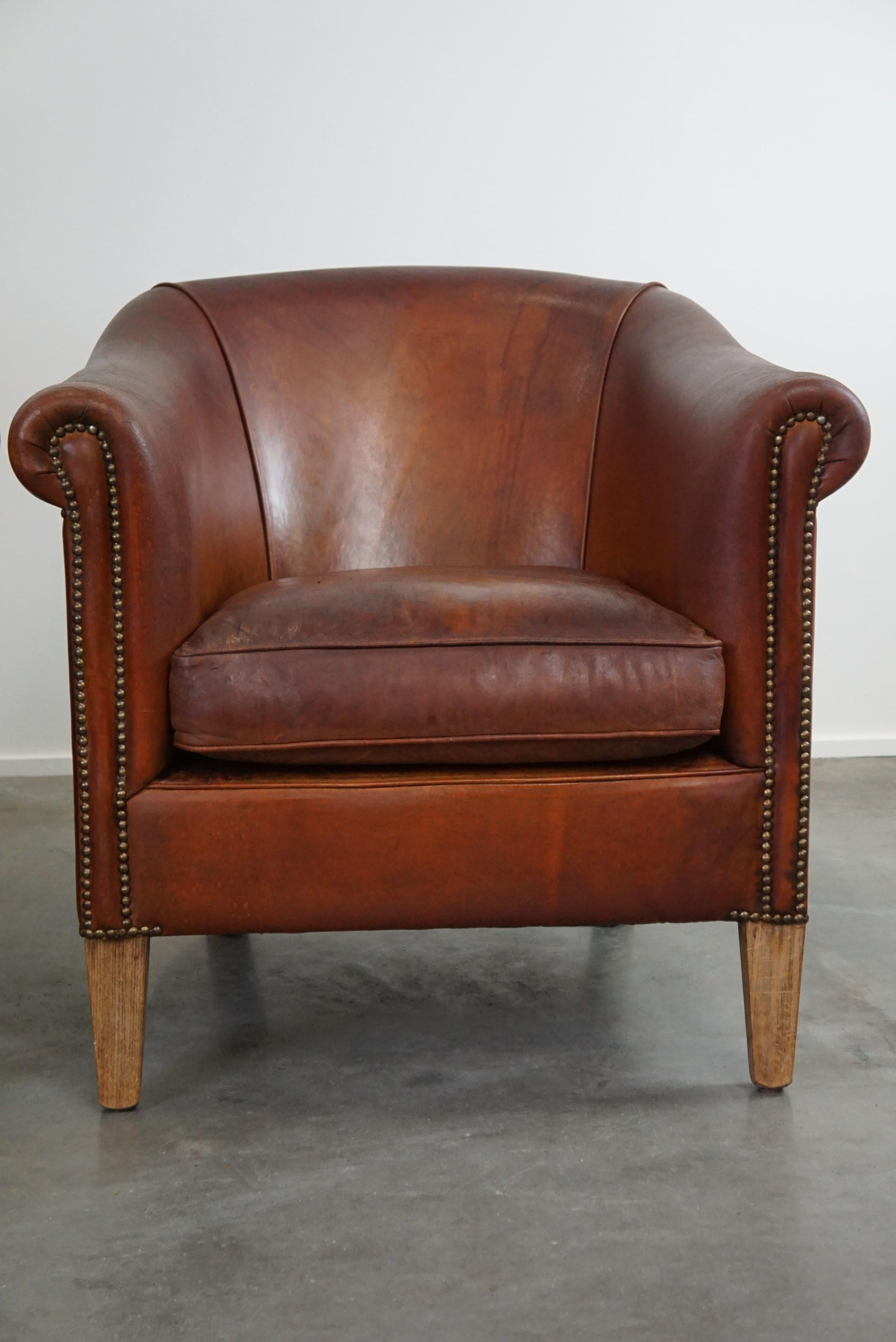 Leather Set of two vintage sheep leather club armchairs with a rugged character For Sale