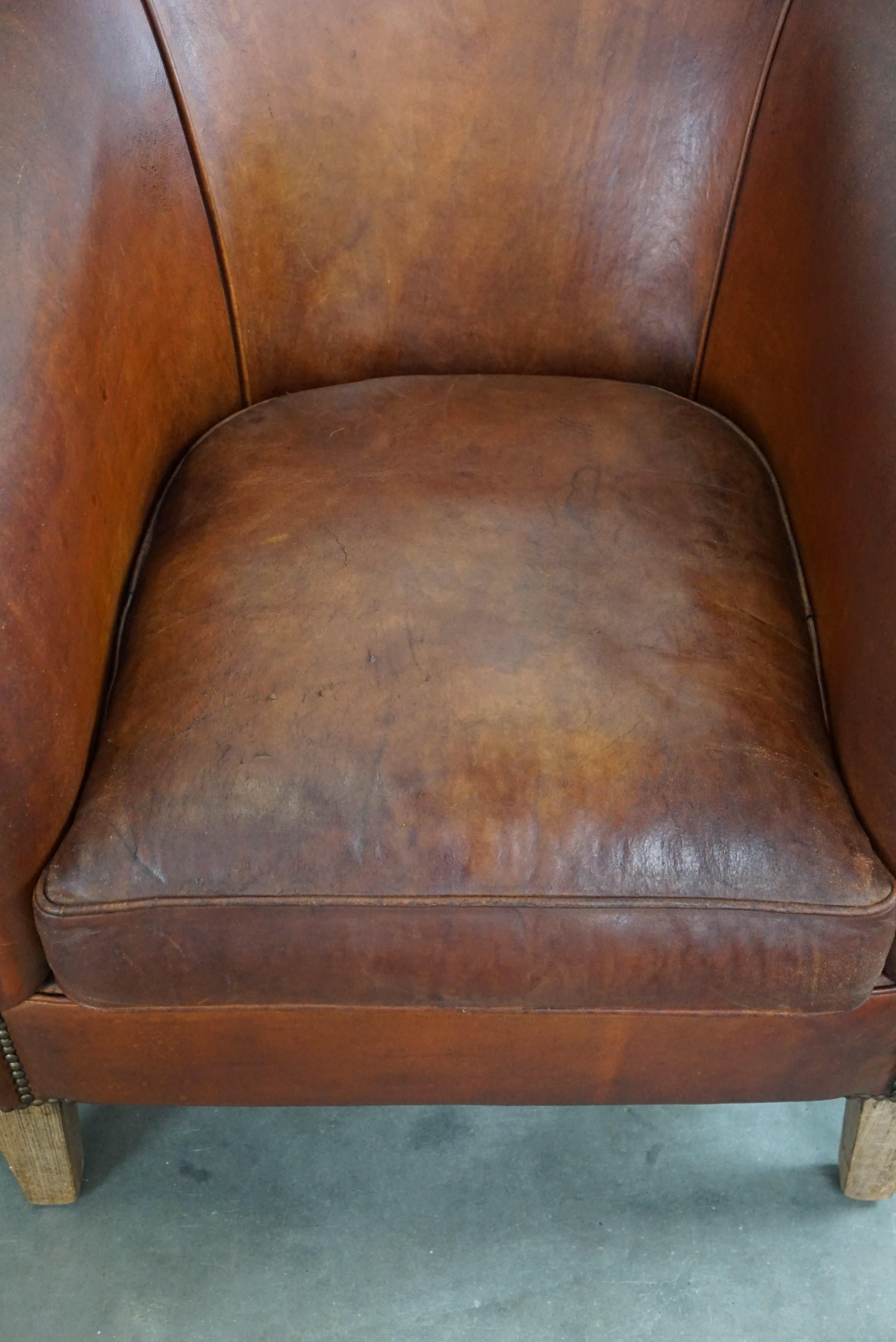 Set of two vintage sheep leather club armchairs with a rugged character For Sale 2