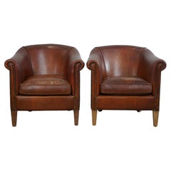 Set of two Used sheep leather club armchairs with a rugged character
