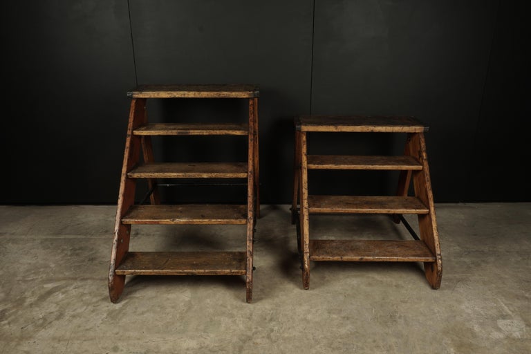Set of two vintage step ladders from Belgium, circa 1940. From the Belgium national railway company. 

Smaller Ladder Dims:
H - 31
W - 31.5
D - 36.5.