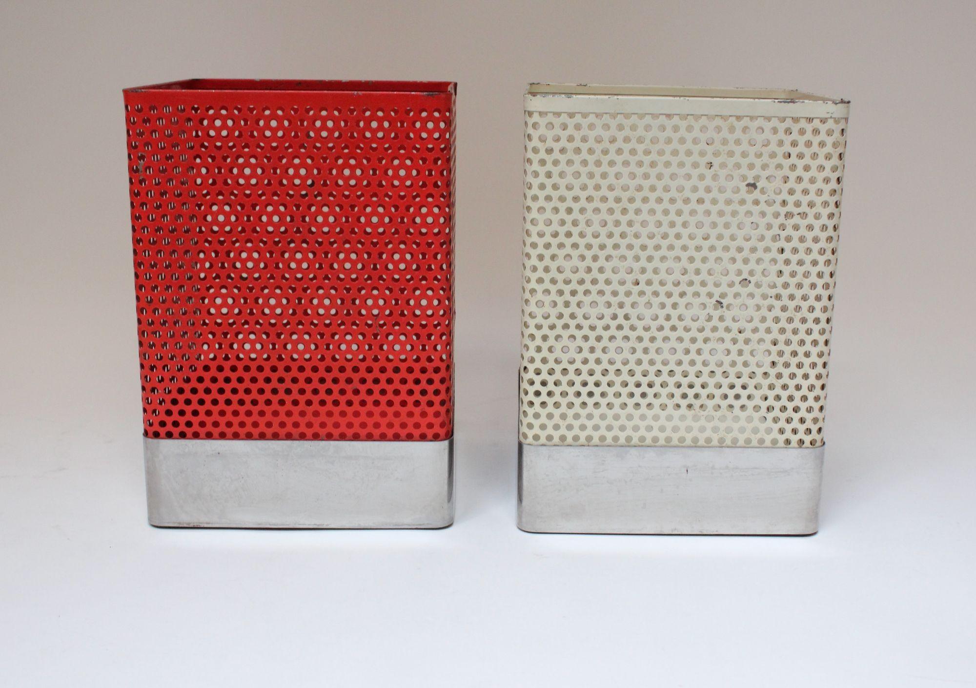 Mathieu Matégot-Style wastebaskets/trashcans composed of perforated metal vessels (one red, one cream) with aluminum trim (ca. 1960s, Italy).
Beautifully aged condition with paint losses and wear to the aluminum, as shown. Additionally, there is one