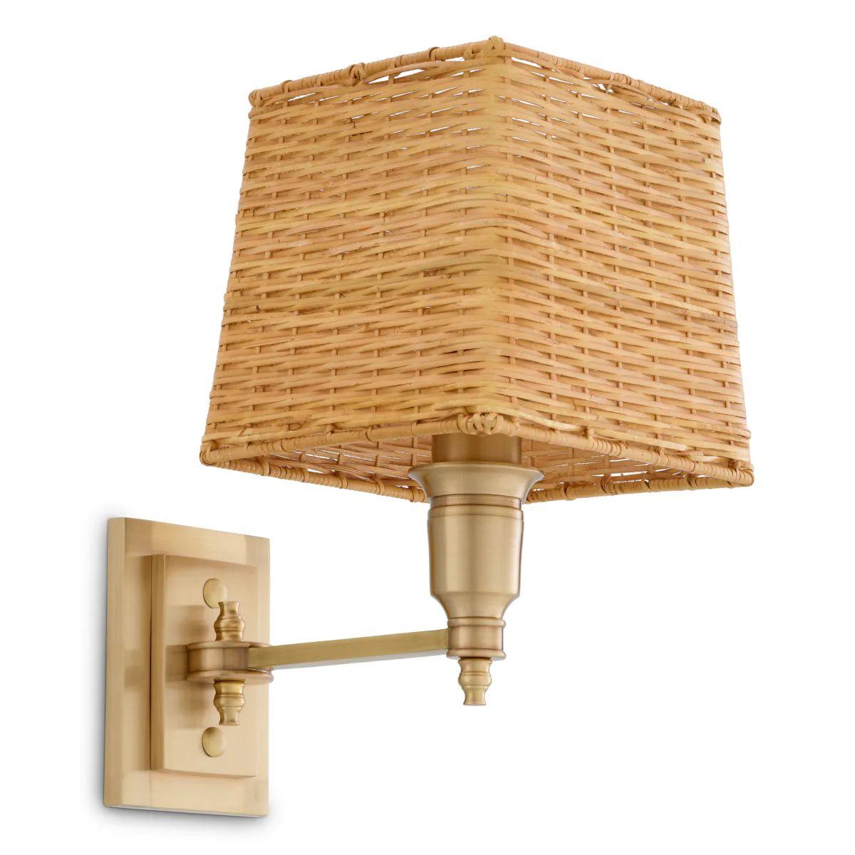 This wall lamp in antique brass finish is a refined lighting piece designed to provide soft, atmospheric illumination while enhancing the character of any interior. Featuring a natural rattan shade that diffuses a warm, welcoming glow, the wall lamp