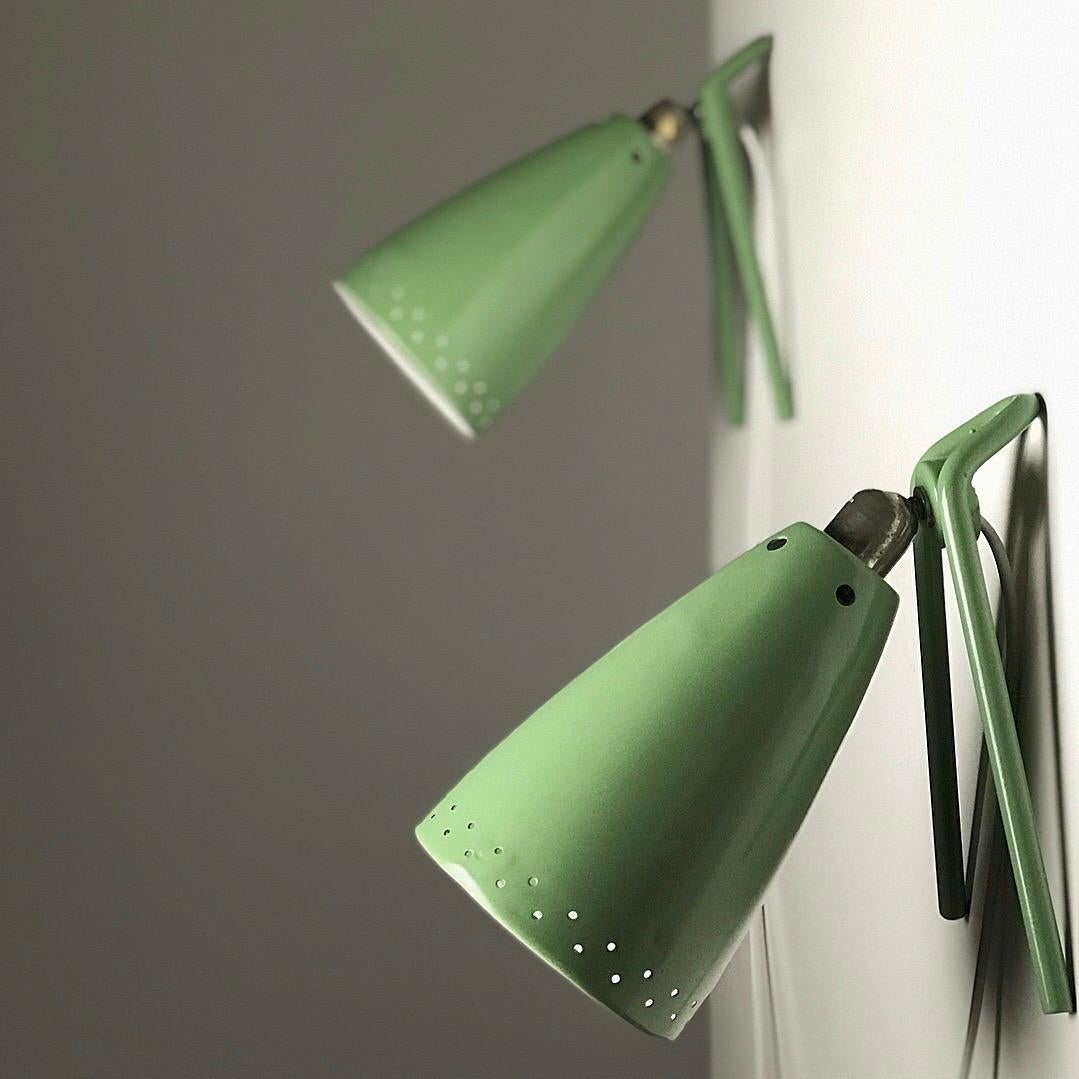 Rare set of two wall or table lights by Louis Kalff for Philips, Nederland, 1950s.

Green mint lacquer on the outside and white lacquer on the inside. The beautiful made shade has perforated holes both top and bottom to give this minimalistic set