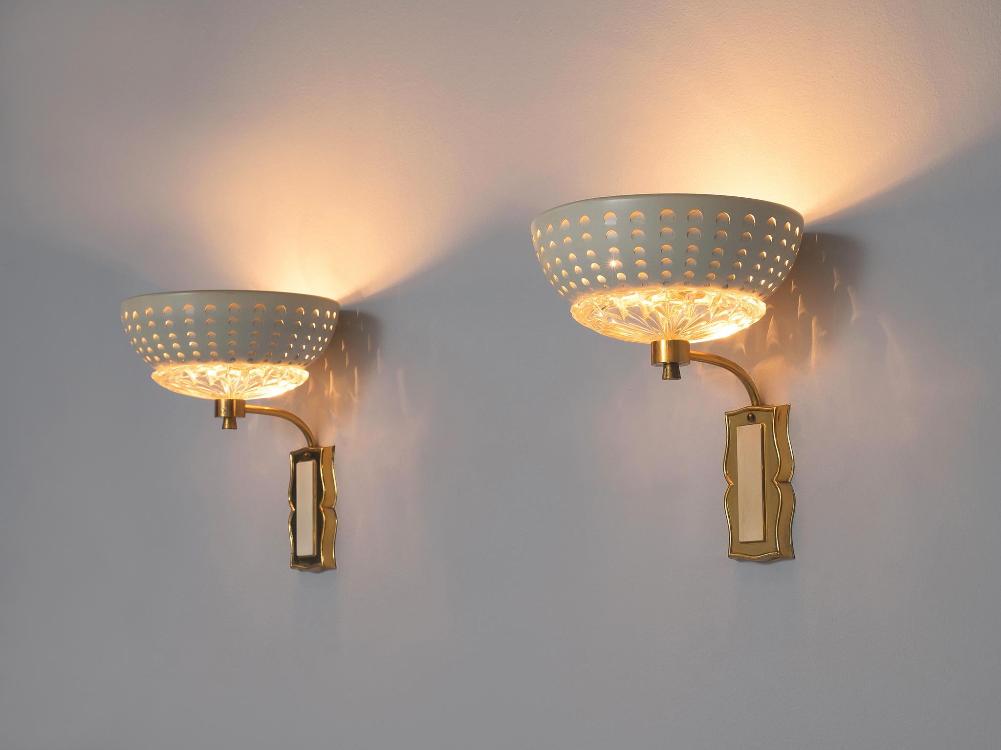 Pair of wall lights, in brass, glass and metal, Europe, 1970s. 

Elegant pair of wall lights in brass. The brass fixture holds an arch on which the bowl shaped lights are mounted. Each light consist of a small structured glass scale, with on top a