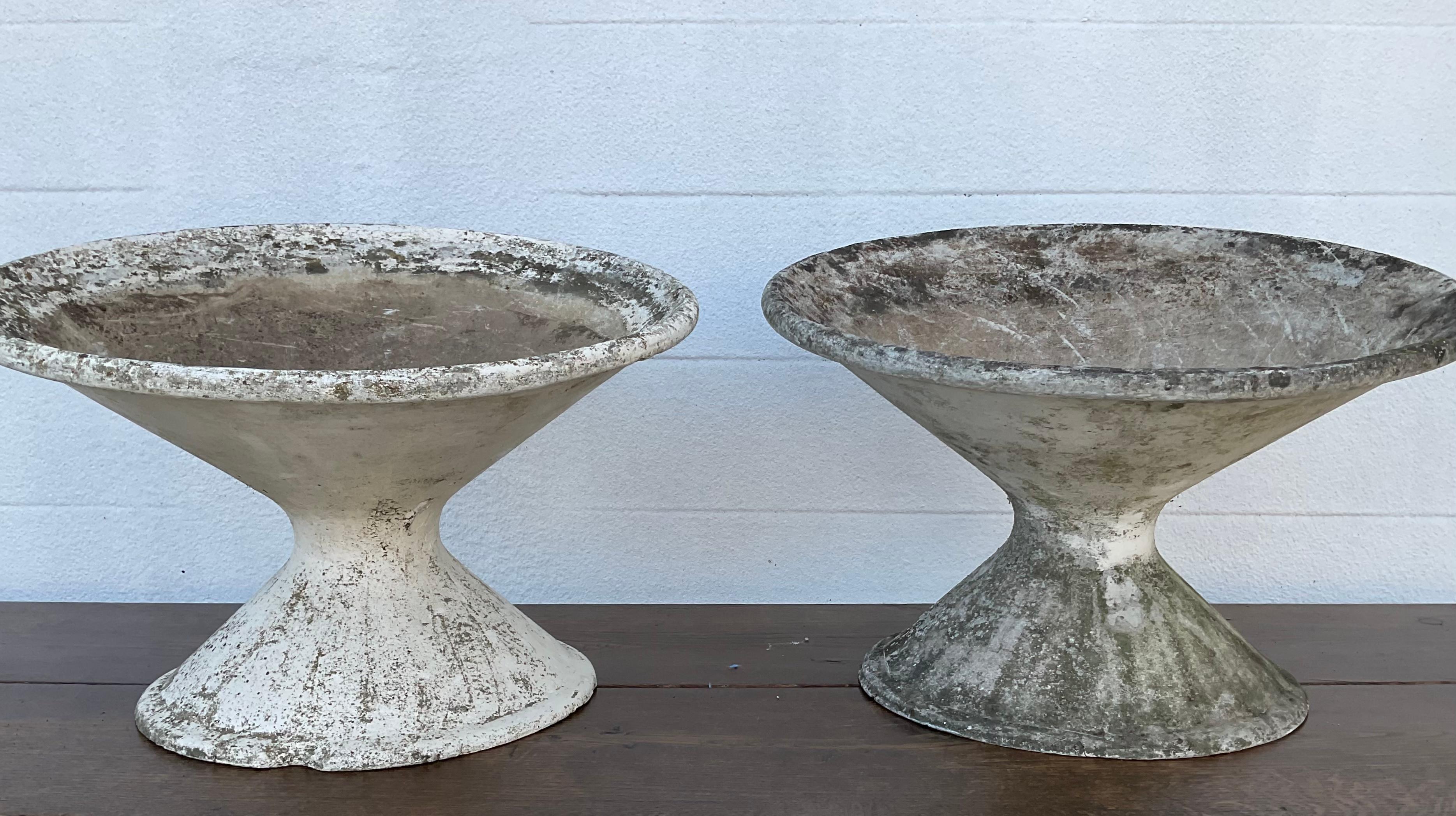 A wonderfully patinated pair of tilted or off-kilter planters that were designed by Willy Guhl. Made from fibrous cement. Beautifully weathered over the decades, making them unique vessels or pieces of art for the home, the patio or in the garden.