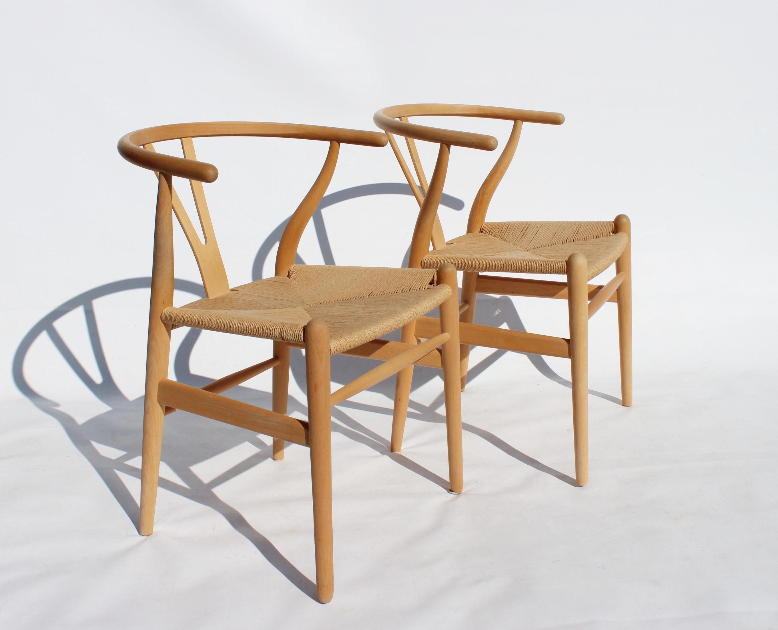 Set of two wishbone chairs, model CH24, of beech and papercord designed by Hans J. Wegner and manufactured by Carl Hansen & Son in the 1960s. The chairs are in great vintage condition.