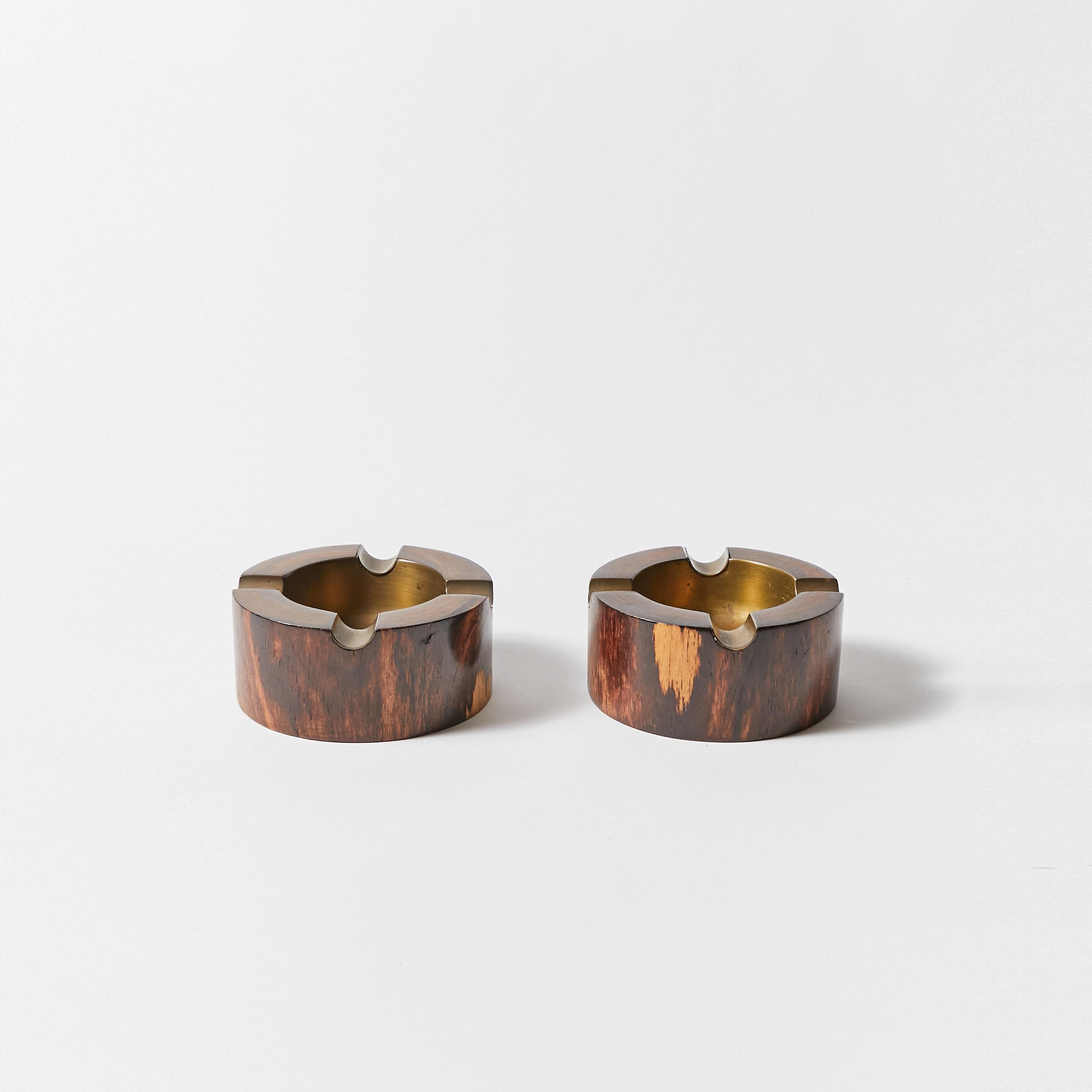 Set of two wooden ashtrays with inset in bronze. Wood seems to be rosewood.