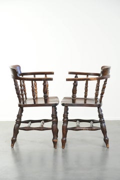 Set of two wooden English antique captain chairs from the late 19th century