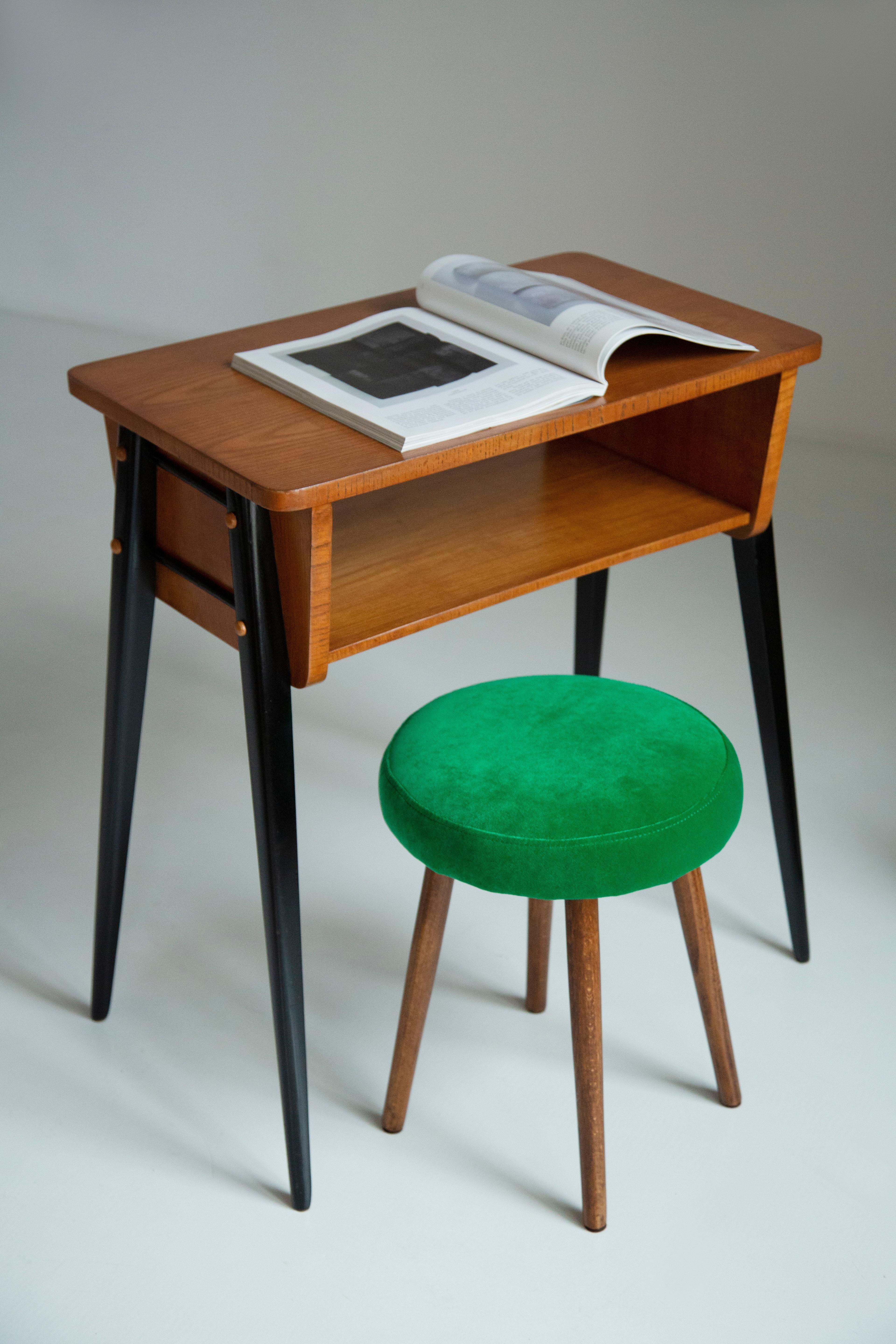Stool from the turn of the 1960s and 1970s. Beautiful fresh green color velvet upholstery. The stool consists of an upholstered part, a seat and wooden legs narrowing downwards, characteristic of the 1960s style. We can prepare this pair also in
