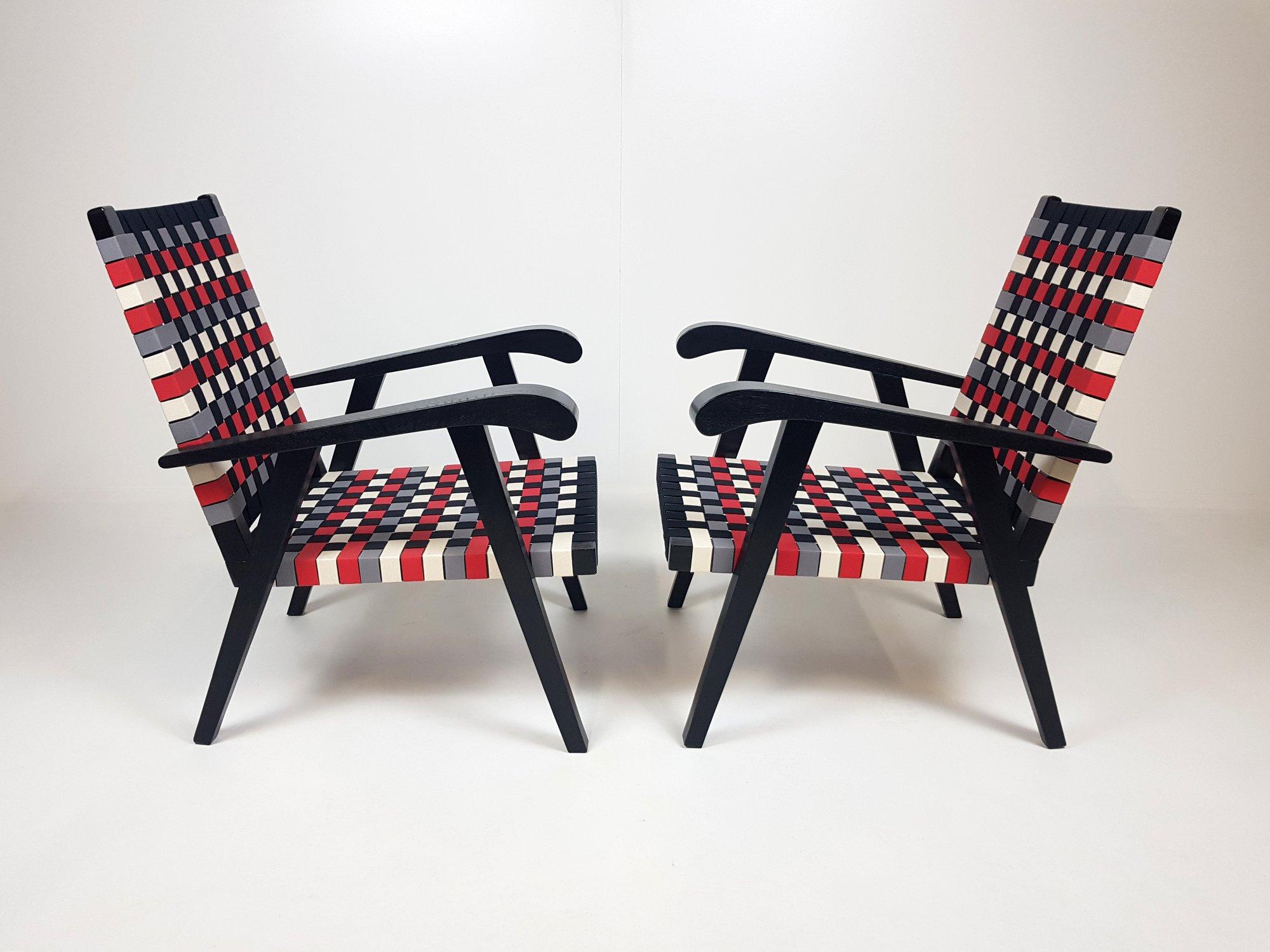 Set of two unique armchairs made of stained black oak and cotton straps. 
Completely renovated.