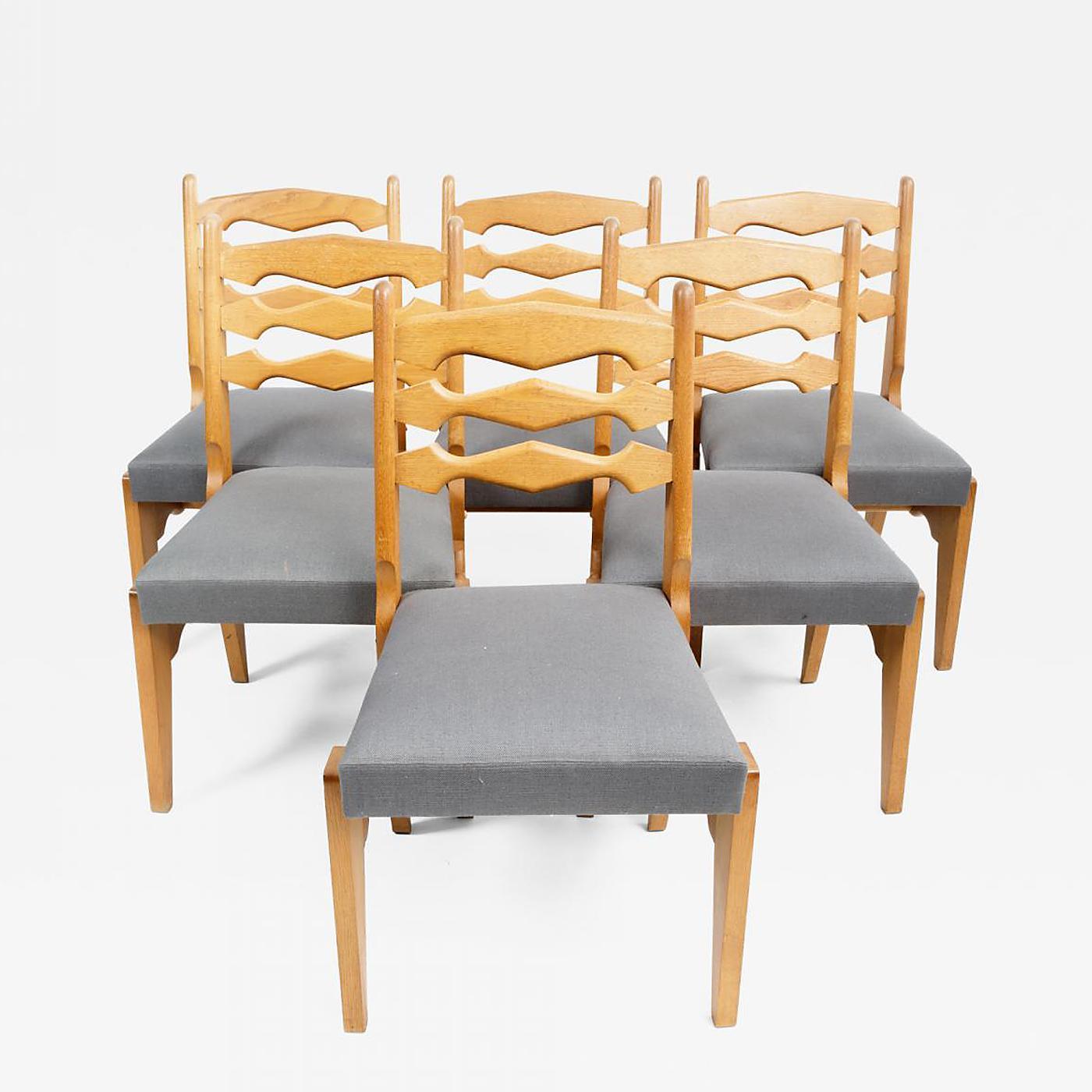 Set of six Oak and Upholstery Dining Chairs by Guillerme et Chambron, France, circa 1970s.

Incredible design consists of solid oak construction. Sculptural frames and backrests with angular legs and new upholstery in a slate blue linen fabric. 