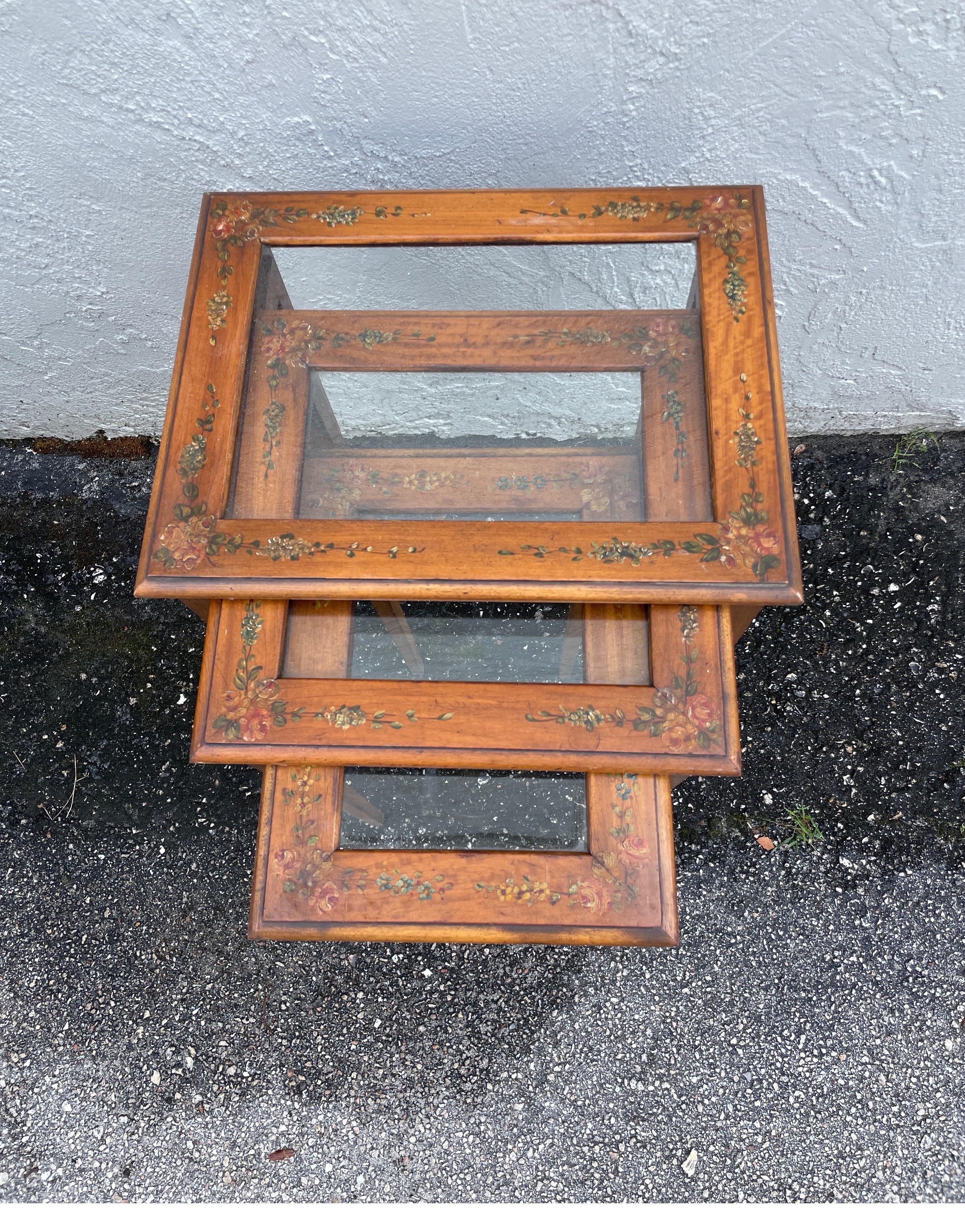 Sweet set of three Adam's Style nesting tables with glass inserts. The largest one measures 15