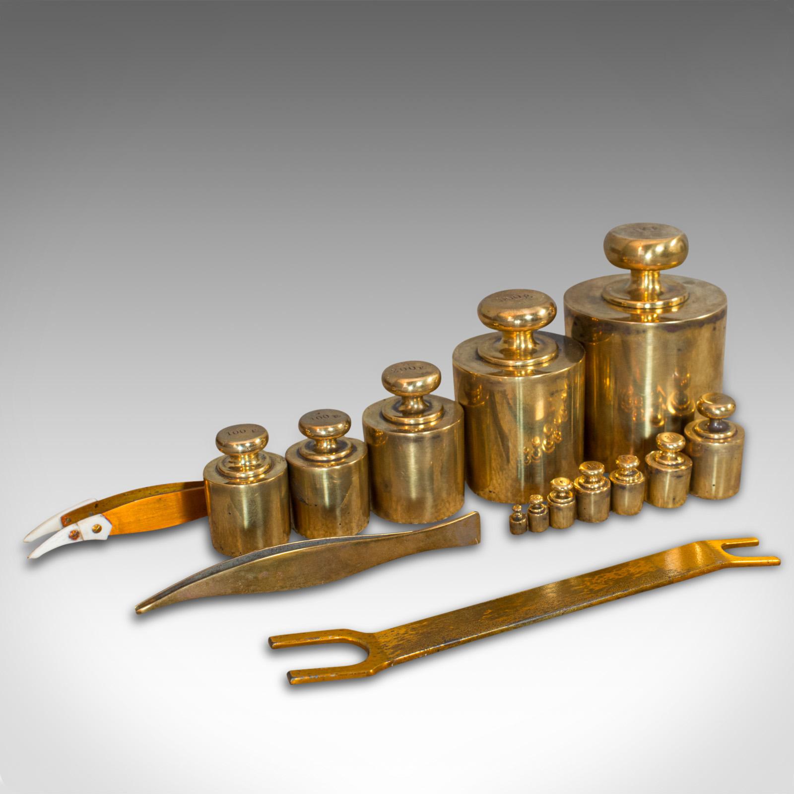 This is a set of vintage balance weights. An English, brass set of scientific apothecary assay weights, dating to the mid-20th century, circa 1950.

A quality set of assayer's weights
Displays a desirable aged patina, one small loss to 2g