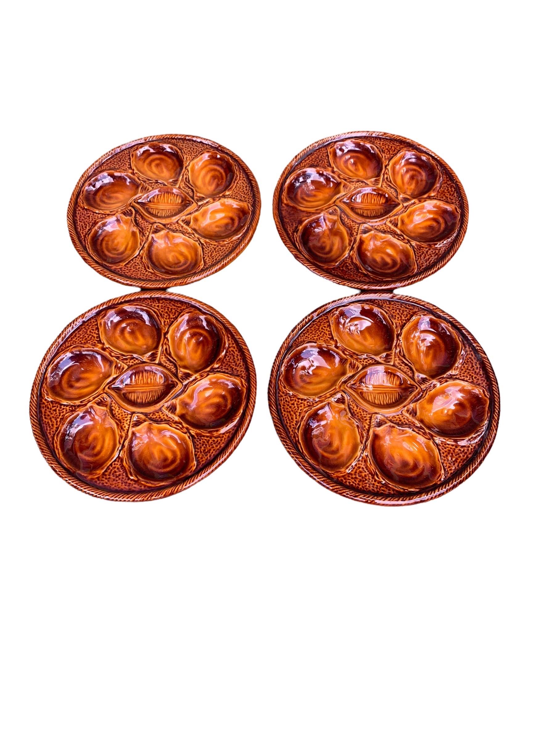 A set of four vintage 1950’s French St Clements oyster plates in the treacle glaze. These plates were produced in the 1950's in the famous St Clement factory in France. They are glazed in a beautiful, rich treacle majolica, each plate holds six