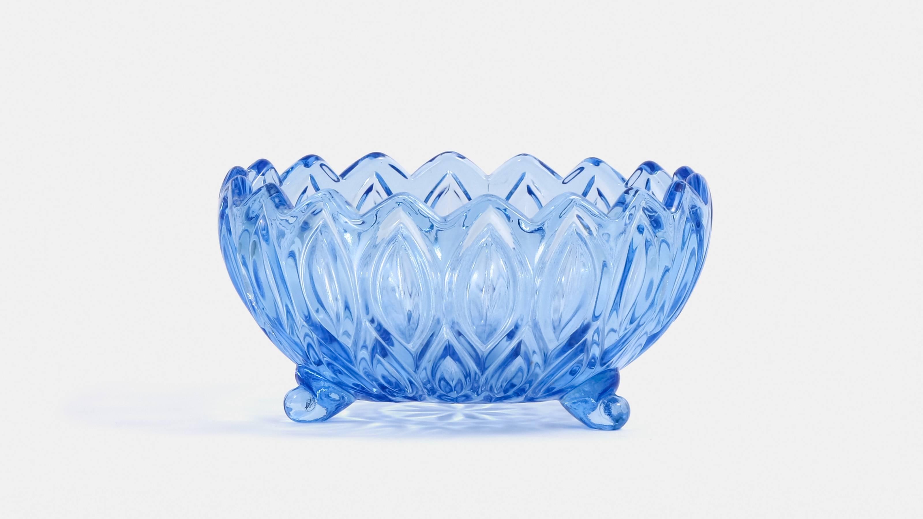 A beautiful set of 1950s blue glass serving bowls consisting of one large bowl and three smaller bowls.