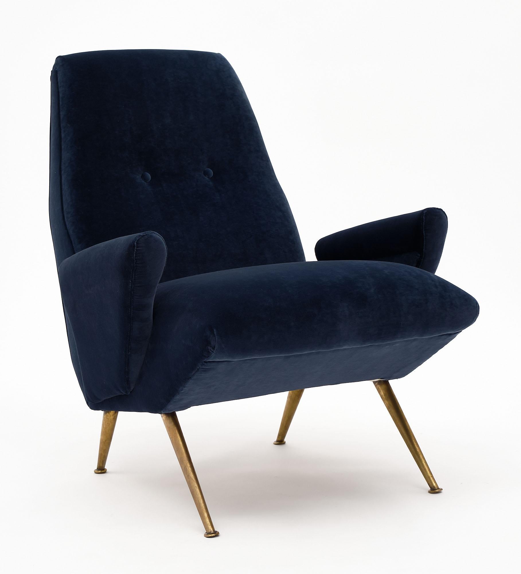 Set of vintage Italian seating by designer Nino Zoncada. This set is from Milan and includes two armchairs and a sofa. They have been newly upholstered in a navy blue velvet blend. We love the solid gilt brass legs and strong lines. The dimensions