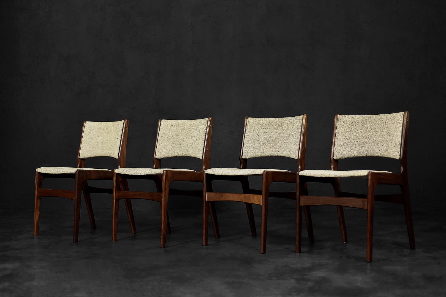 This set of four elegant chairs model 89 was designed by Erik Buch for the Danish manufactory Anderstrup Møbelfabrik during the 1950s. They are made of high-quality teak wood in a dark shade of brown. The profiled, comfortable seat with the backrest