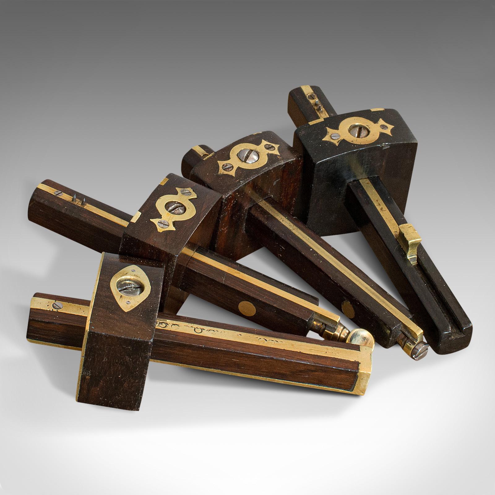 This is a set of vintage mortise gauges. 4 English, rosewood and brass carpenter's tools, dating to the mid-20th century, circa 1950.

Fascinating midcentury craftsman's tools
Displaying a desirable aged patina
Rosewood shows fine grain