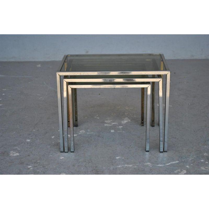 Set of vintage 1970s Jansen style nesting tables with smoked glass top. Amounts double patina gold and silver. Overall dimension of the largest table: height 40 cm for a width of 52 cm and a depth of 37 cm.

Additional information:
Style: Vintage