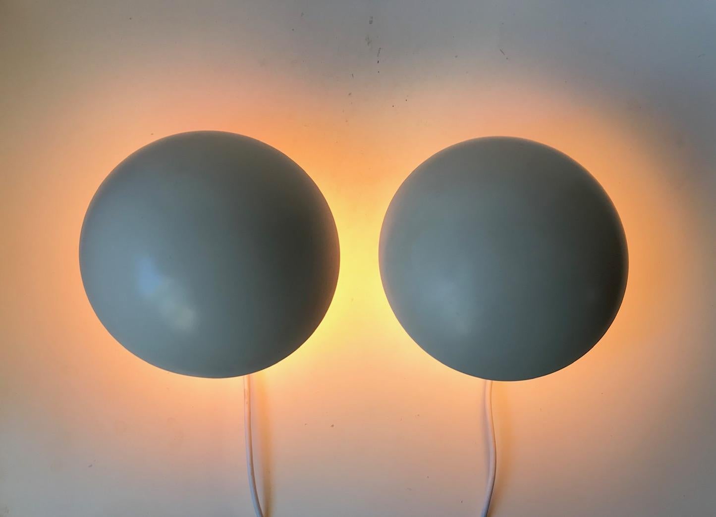 A set of white and pink PH hat wall lamp designed by Poul Henningsen in the late 1970s and manufactured by Louis Poulsen in Denmark. Please notice the two different on/off switches. Both labeled with paper-stickers from Louis Poulsen.
