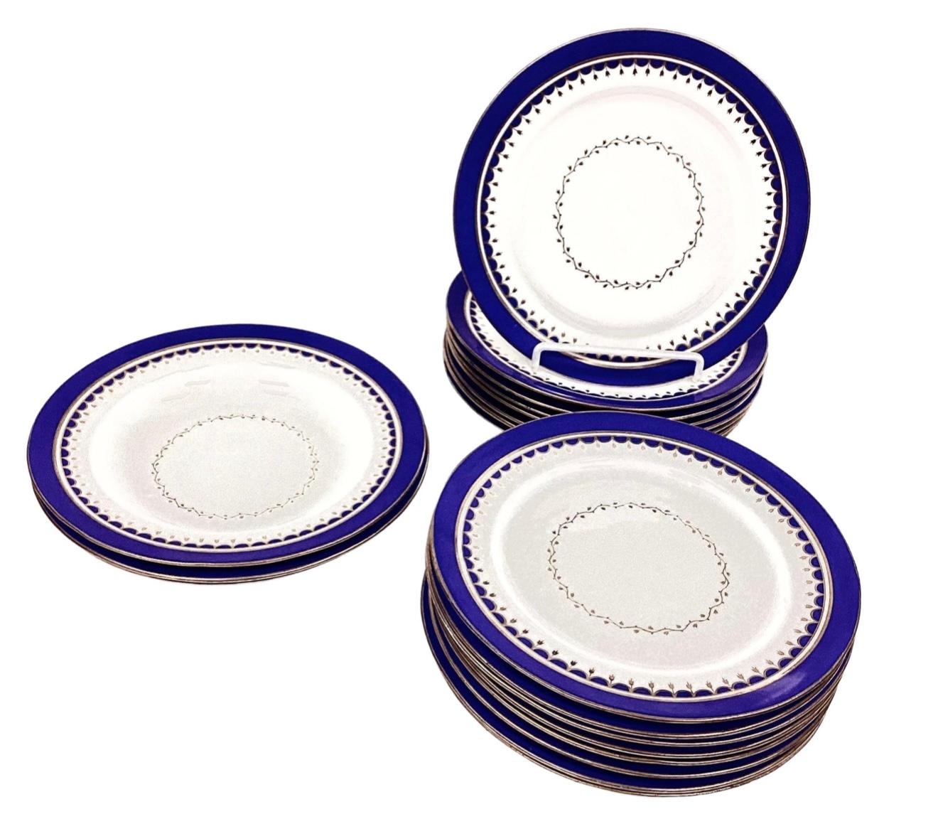 Set of early 20th century Porcelain dinner plates (16 total) and large bowls (3 total). Beautiful cobalt blue on edge with smooth gold trim and tiny gold leaves in center. No markings on reverse side. Possibly from Russia or France. Good condition