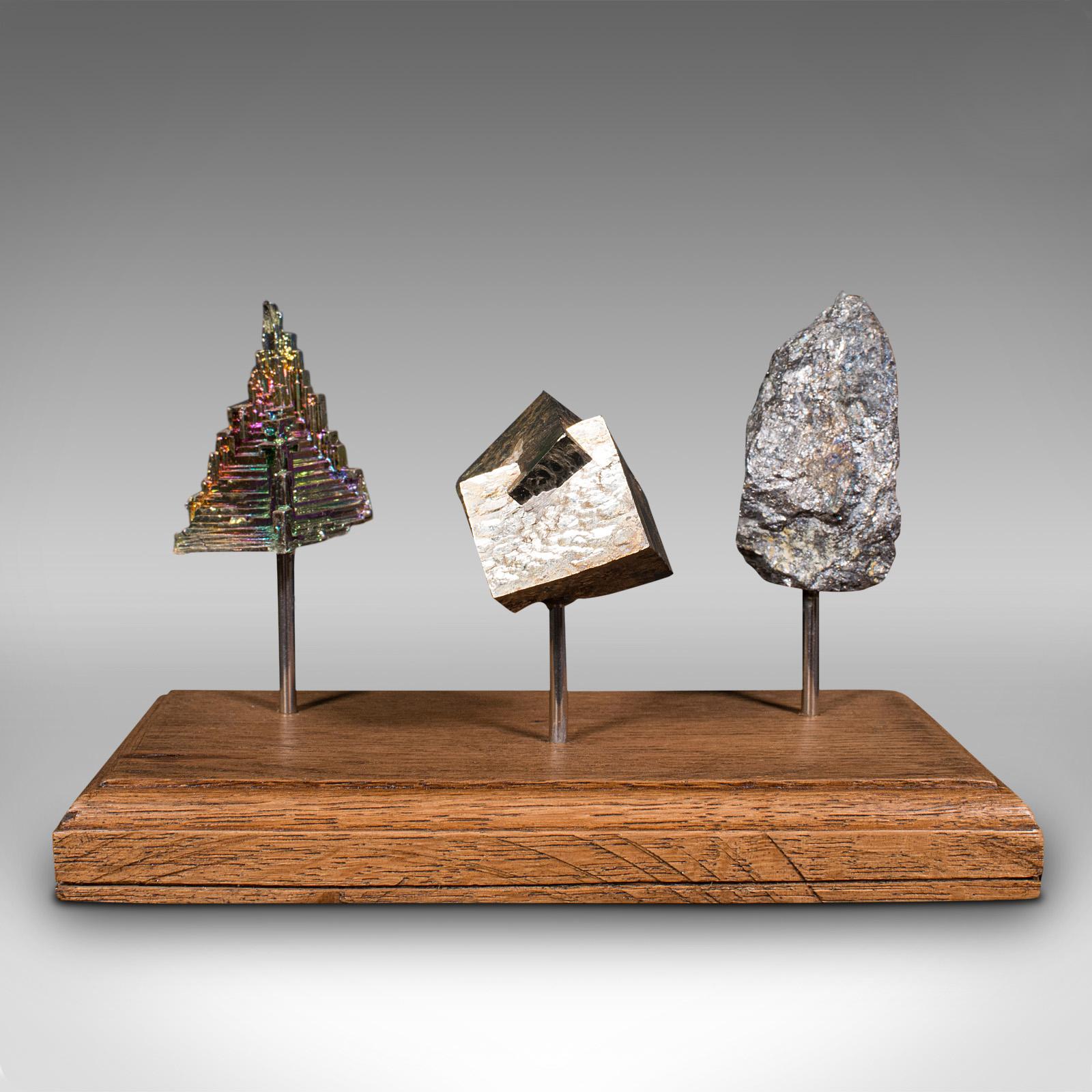This is a set of vintage rare earth metals. A Continental, bismuth, pyrite and galena decorative display on oak plinth, dating to the late 20th century, and much, much earlier.

Fascinating decorative piece, ideal for the desktop
Displays a