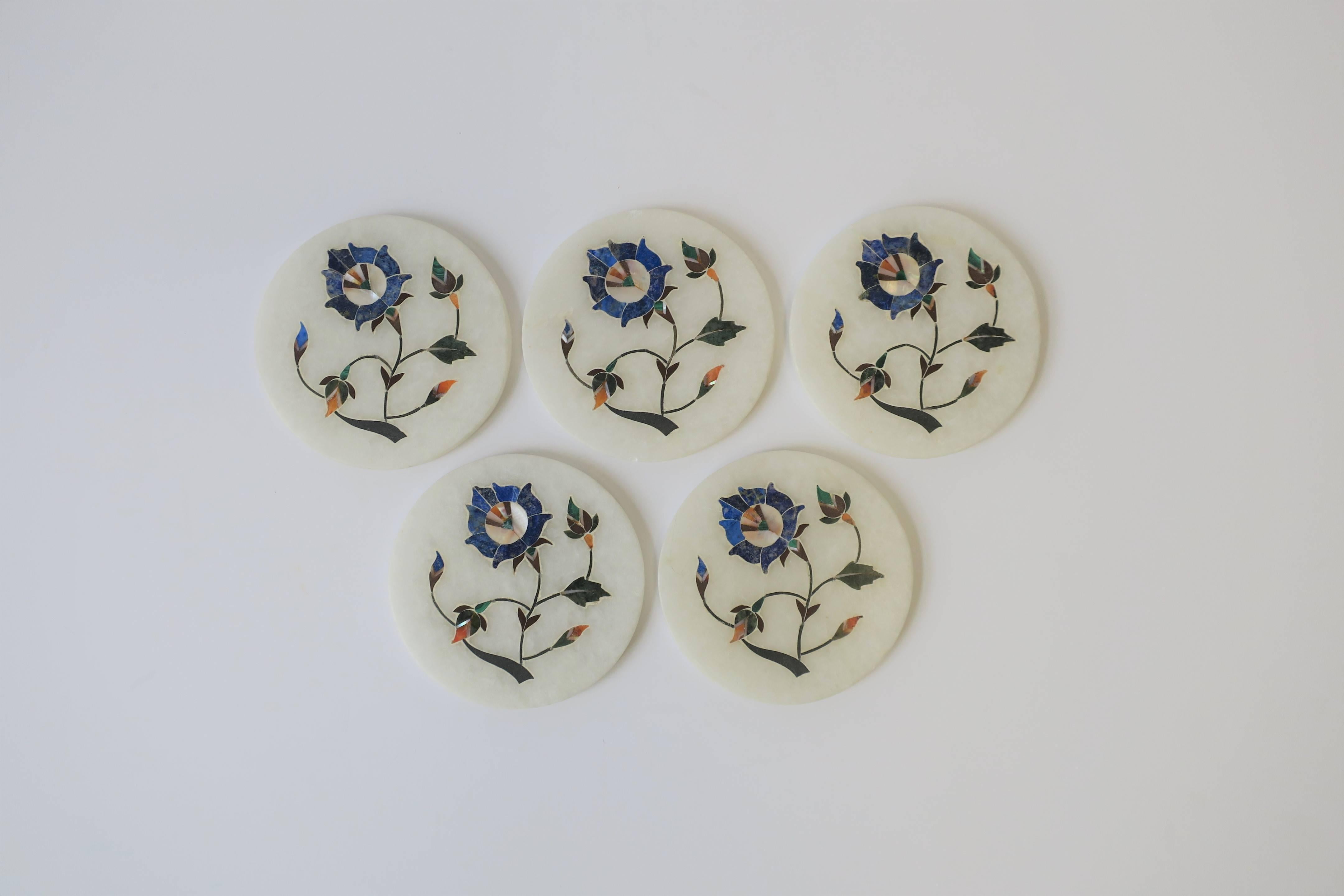 A beautiful set of five vintage handmade white granite marble coaster set with inlaid top design, in the style of Anglo Raj, circa 20th century India. The white granite marble is inlaid with various semi precious stones including, blue lapis lazuli,