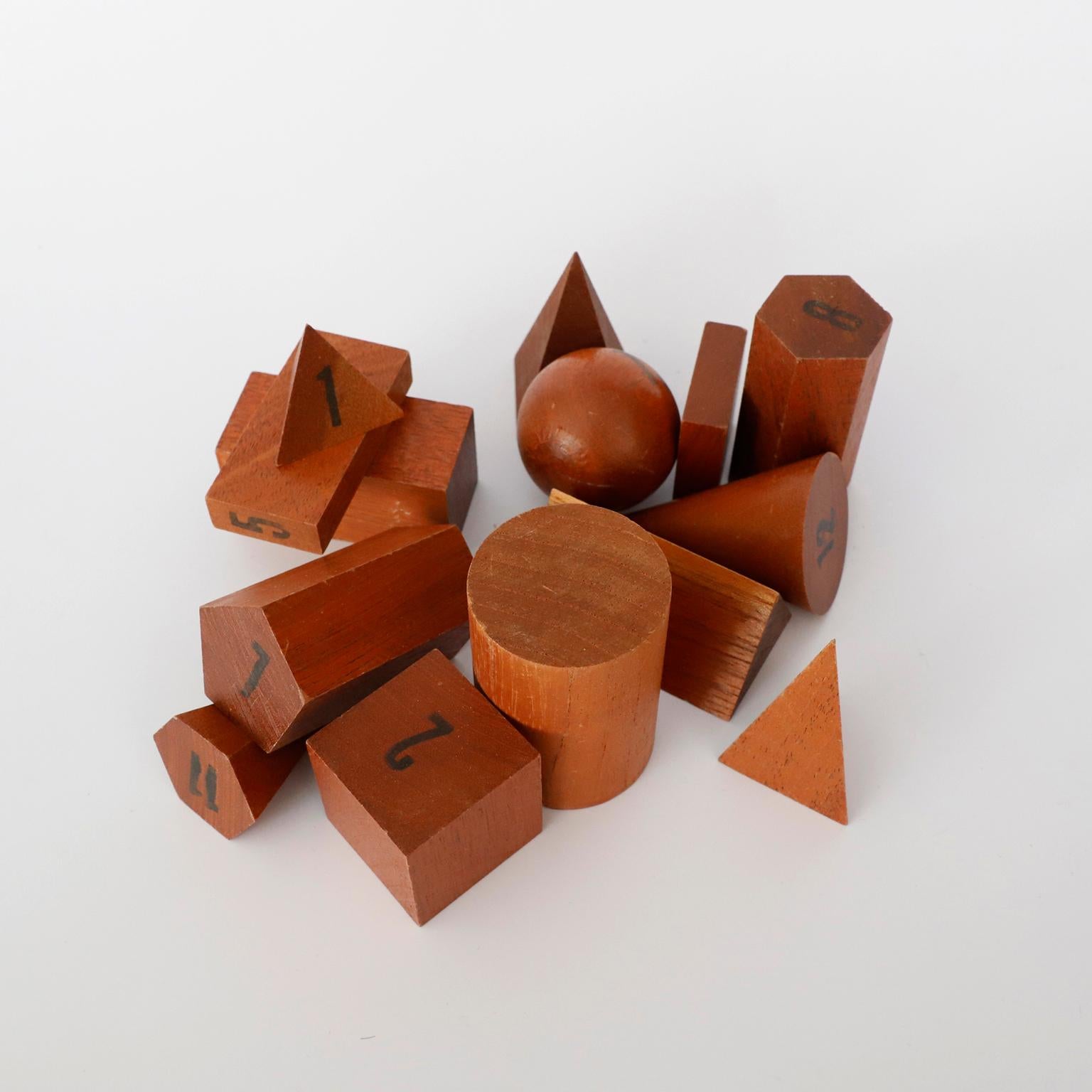 Circa 1970. We offer this set of 14 vintage wooden geometric shapes. These wooden models were used in teaching solid geometry and mathematics, original box.