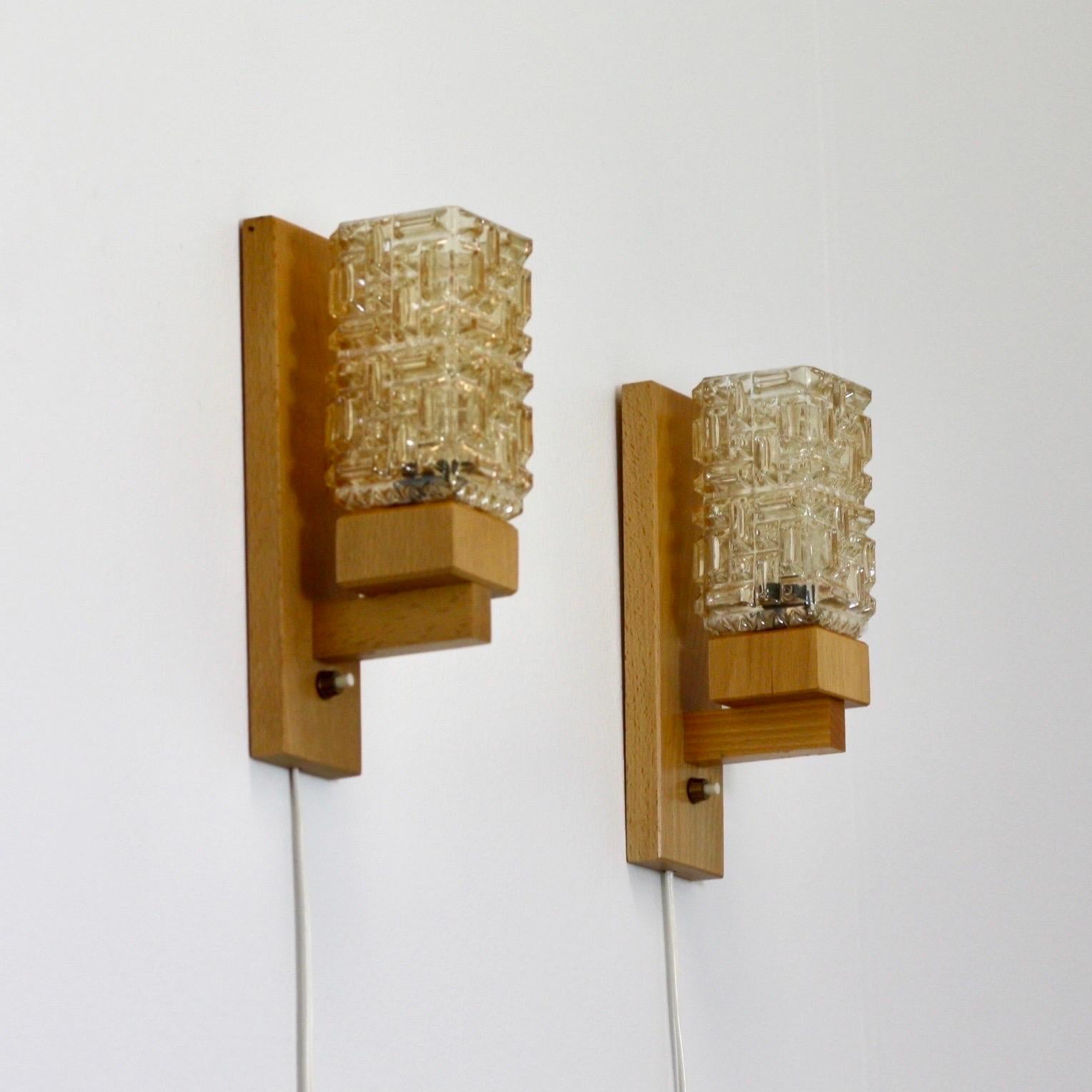 Wonderful set of Danish Modern wall lamps in Scandinavian beech wood and amber colored glass shades. The lamps were made in the 1970s by the small Danish workshop 'Vitrika'. 

* A set (2) beech wood wall lamps with amber glass shades
* Manufacturer: